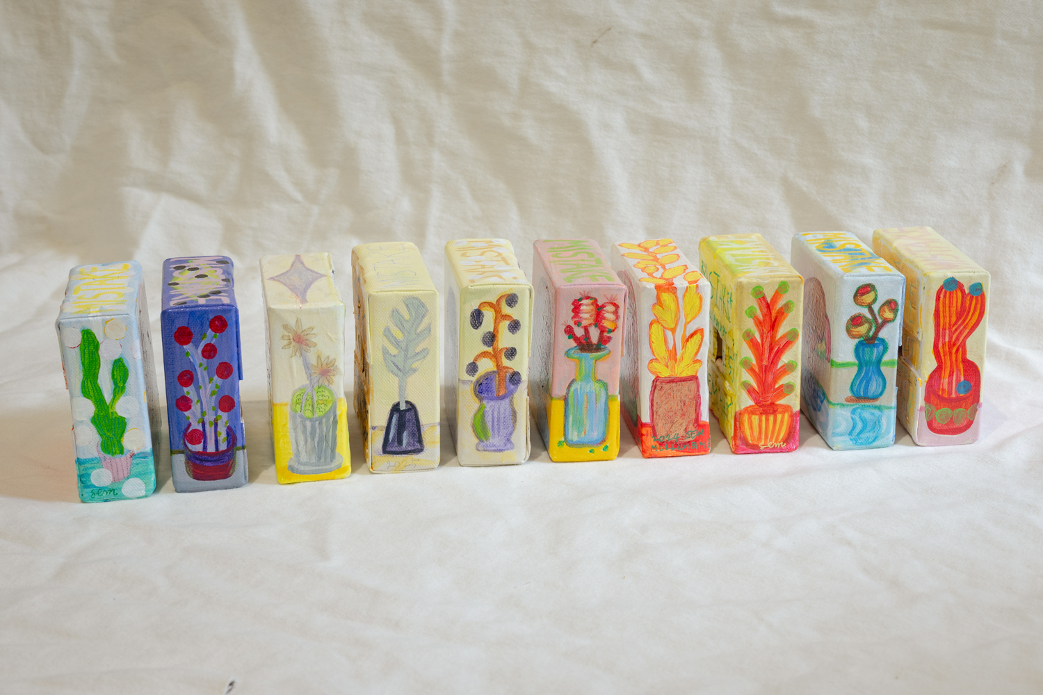 I enjoy painting small plants and flowers on the sides of the canvas