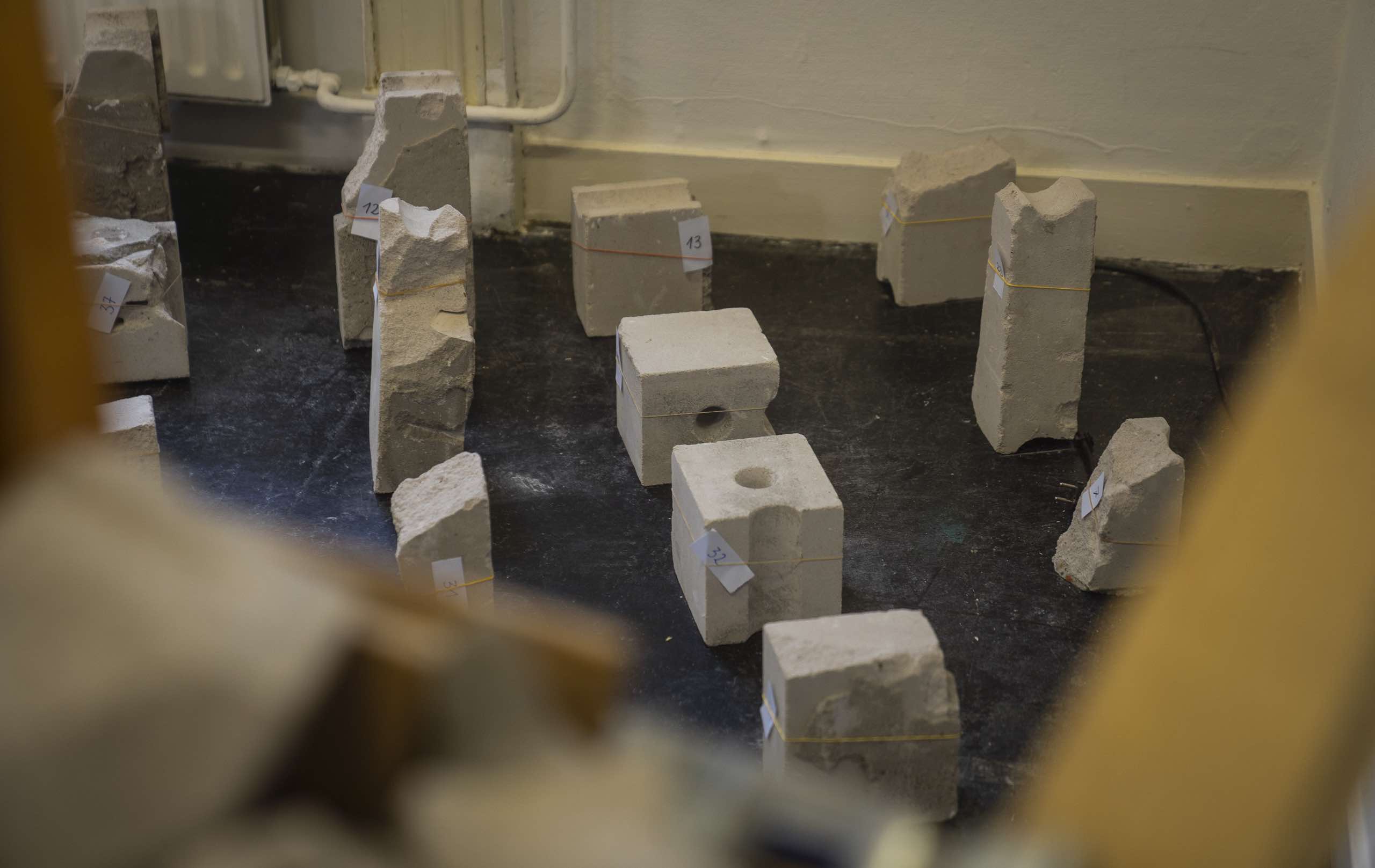 Physical archive of concrete rubble pieces.