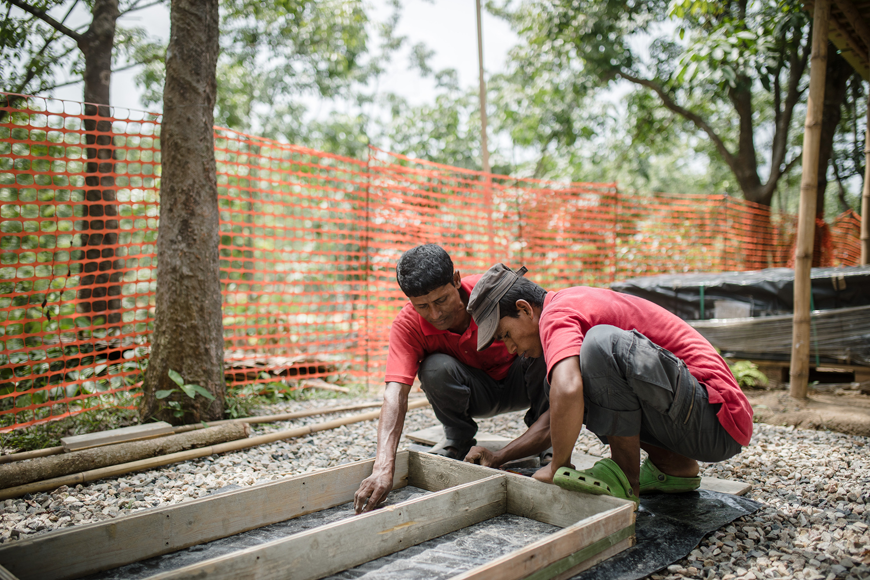 Field Hospital's technical team members, Juhim and Alijuhar, preparing to make concrete tiles.