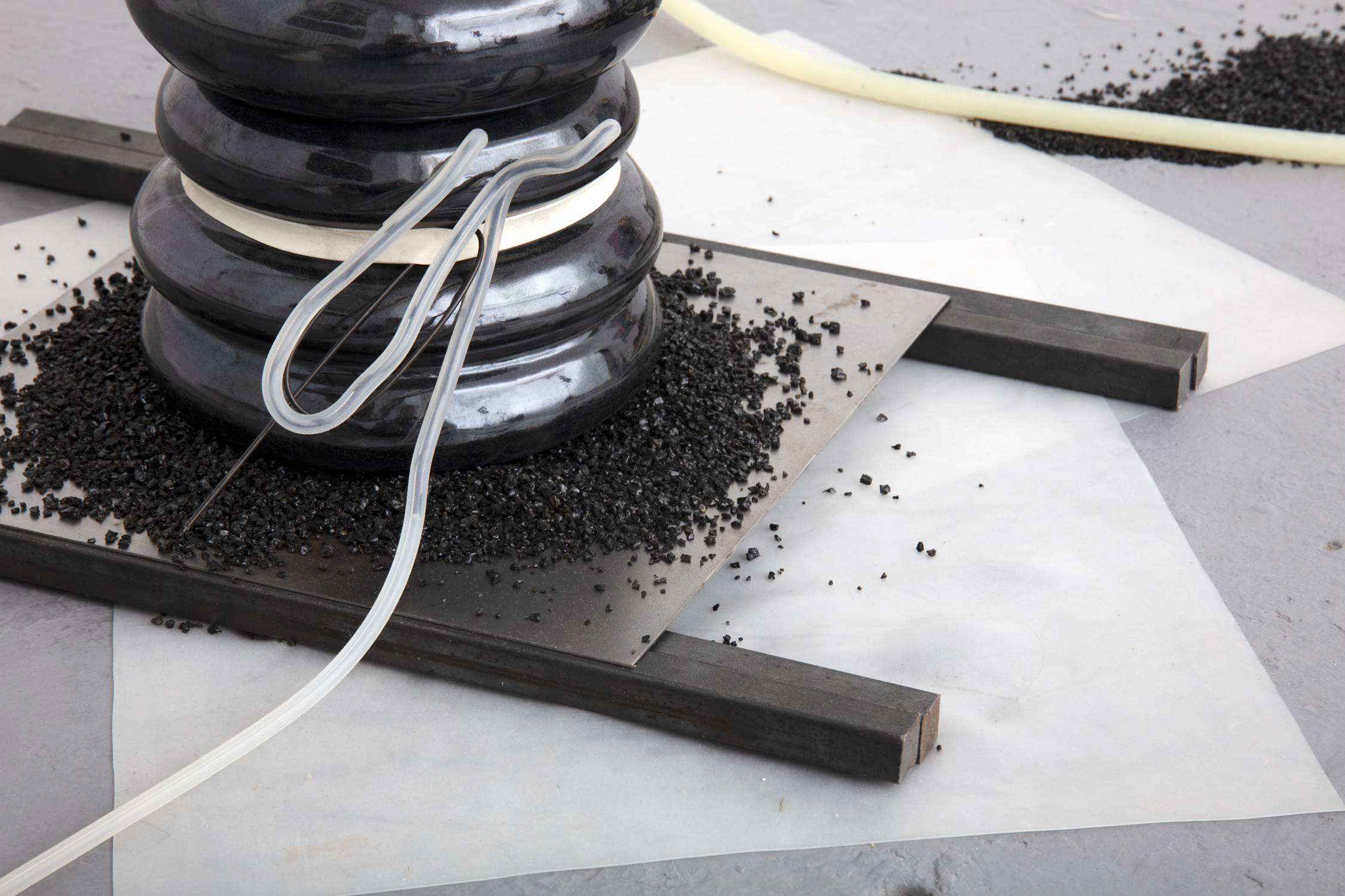 The propensity of things, 2019, [various dimensions], Slade Interim Exhibition   Whey protein powder, silicone, black mirror glaze on terracotta ceramic,   volcanic sand, wire, rubber band, glass, steel 