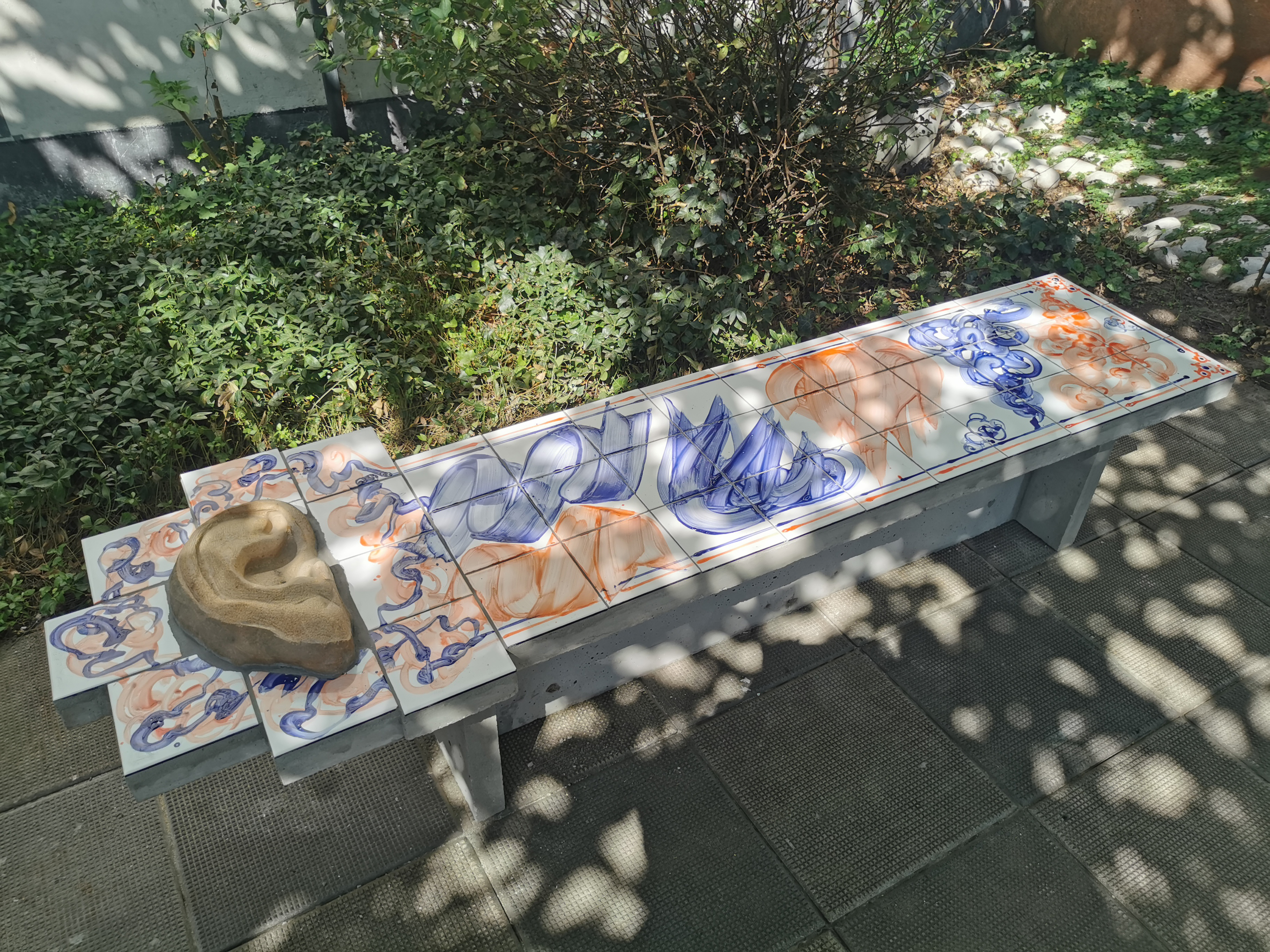 Torch Ash, 2025, black rhyolite, river stones, glazed ceramic, concrete, ash, water, various sizes