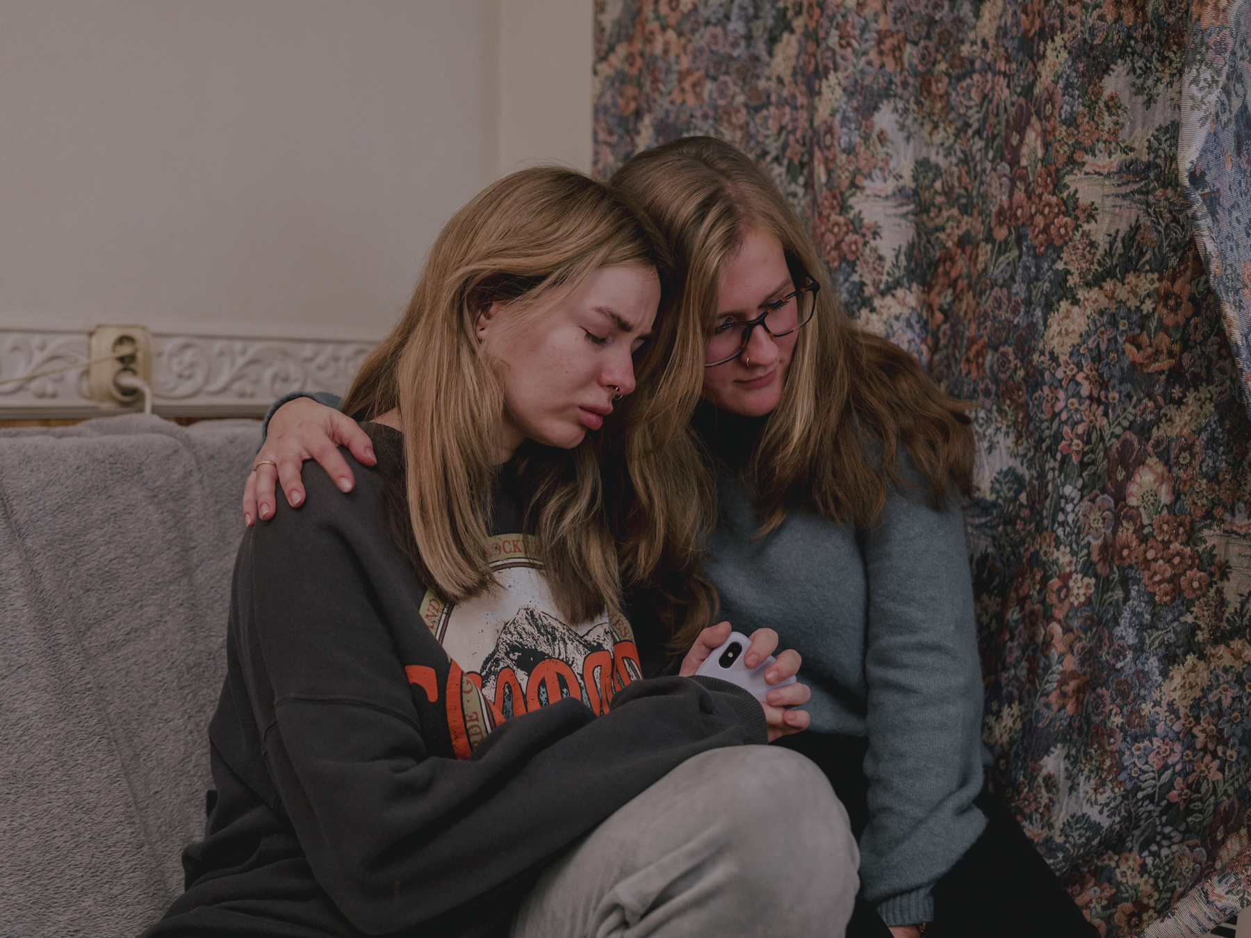 Zhenya (left) has her brother in Russian captivity and does not know if he is still alive. Her cell phone is always on and always with her, hoping that the relieving call will come from her brother. Katherine (right) lost her apartment in Mariupol in 2022, where she lived with her partner, who is also in unknown status as a Russian prisoner of war. Kyiv, 22.11.2022.