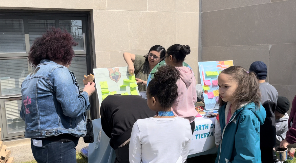 Lynn students interact with a student's tabling event on Earth Day