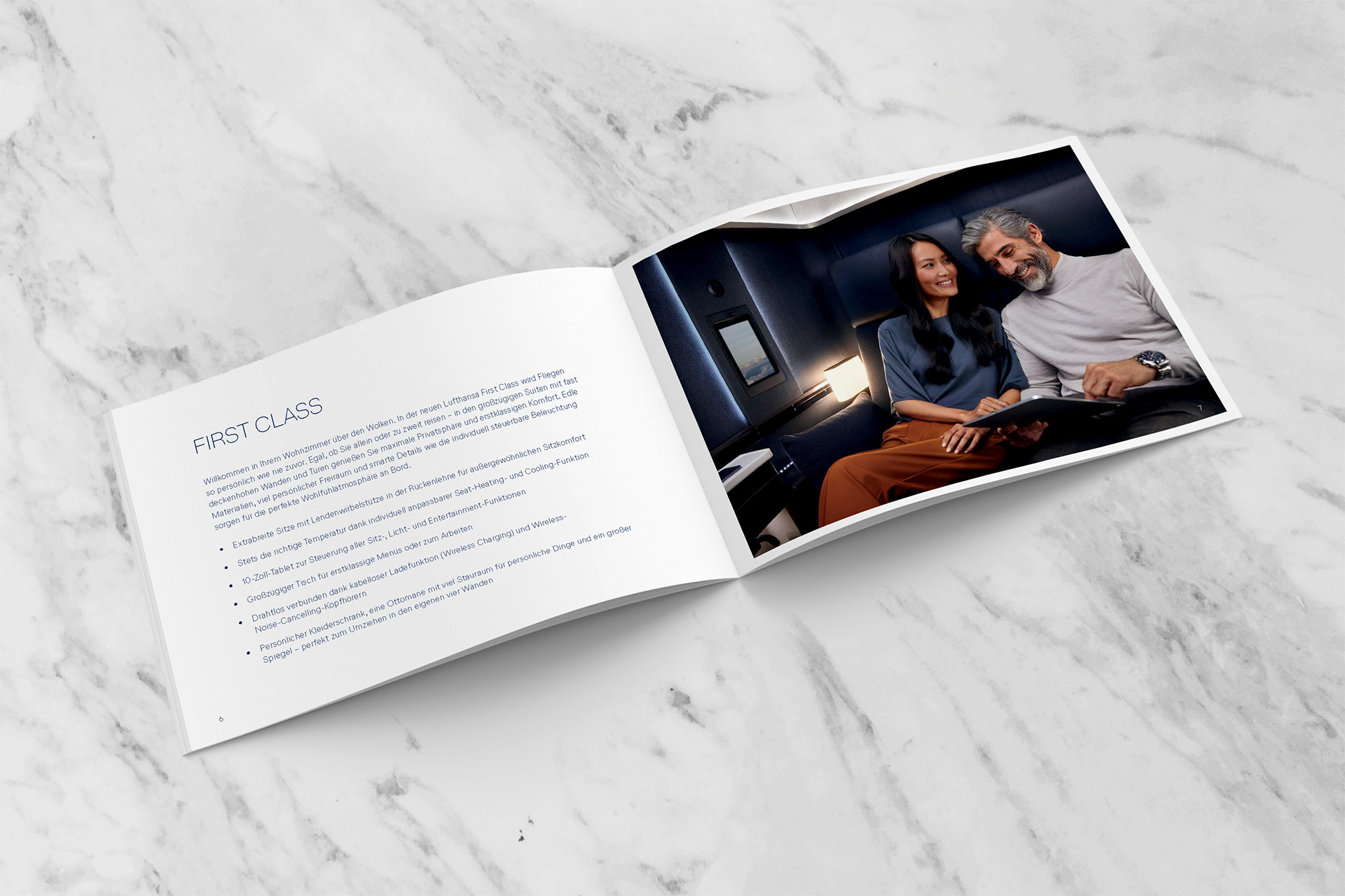 Allegris leaflet open, showcasing the First Class Suite Plus Seat: The image on the open page depicts a couple enjoying inflight entertainment