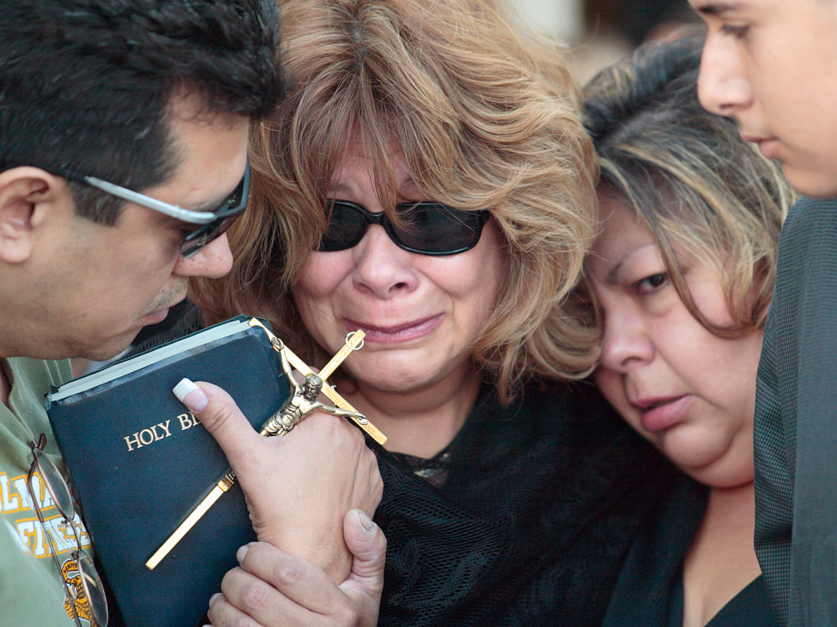 Gloria Salazar, center, is comforted by family members at the funeral of her son William in Pico Rivera, California, on October 23, 2004. Marine Cpl. William Salazar was killed by a suicide bomber in Iraq on Oct. 15. He was 26 years old. Ho-Yen Tsang for The San Gabriel Valley Tribune