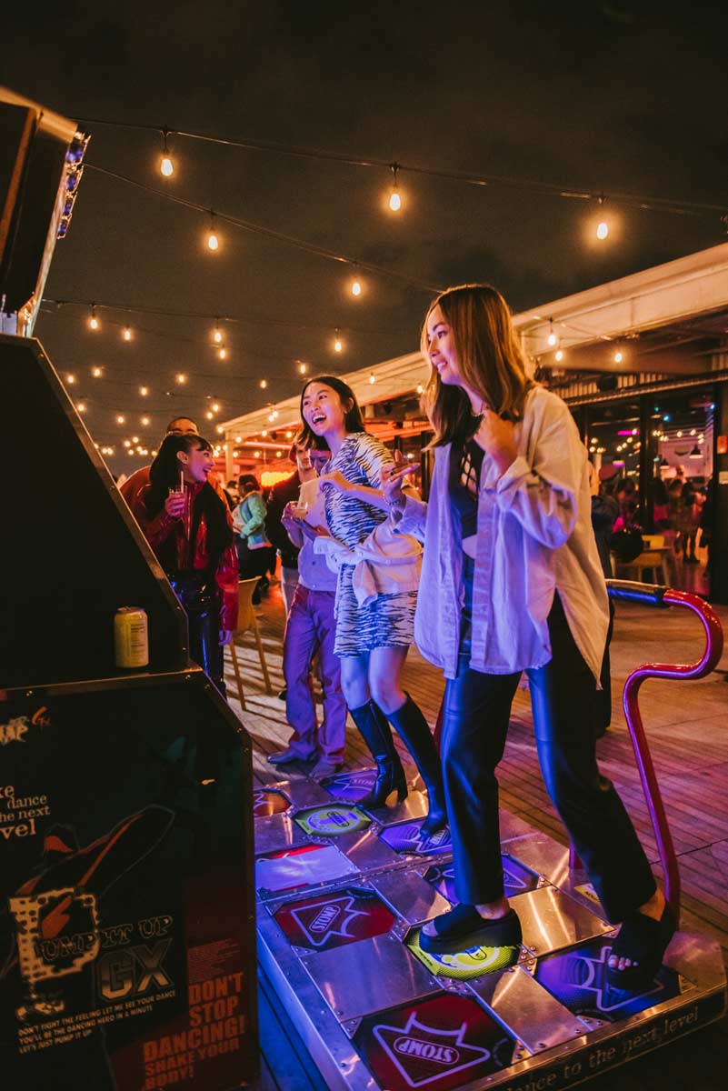 2 people competing on Dance Dance Revolution machine