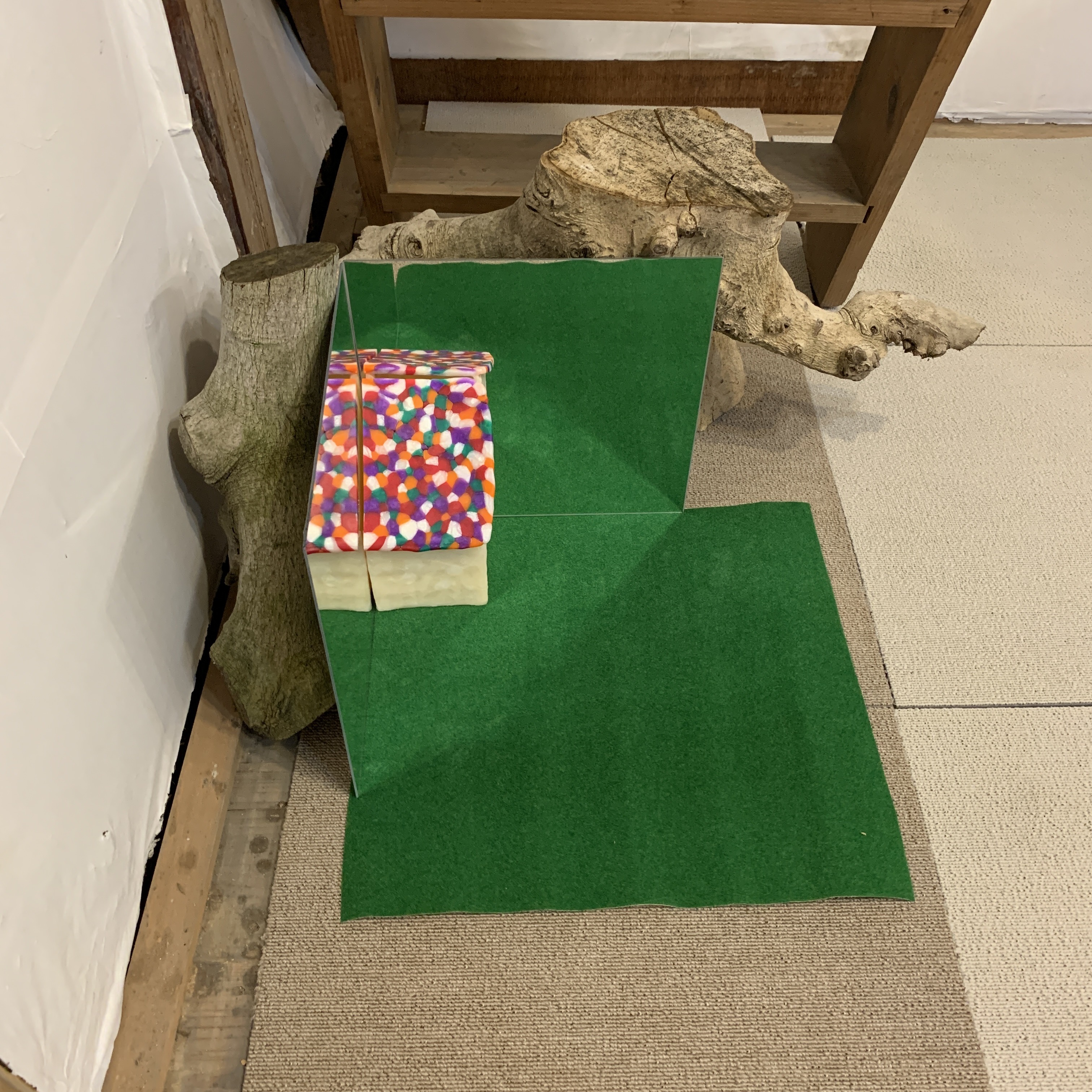 Installation views of Mirror from I Wish My Home Was Here series2022Polymer clay, mirror, artificial grassH12 x W16 x D16 inches