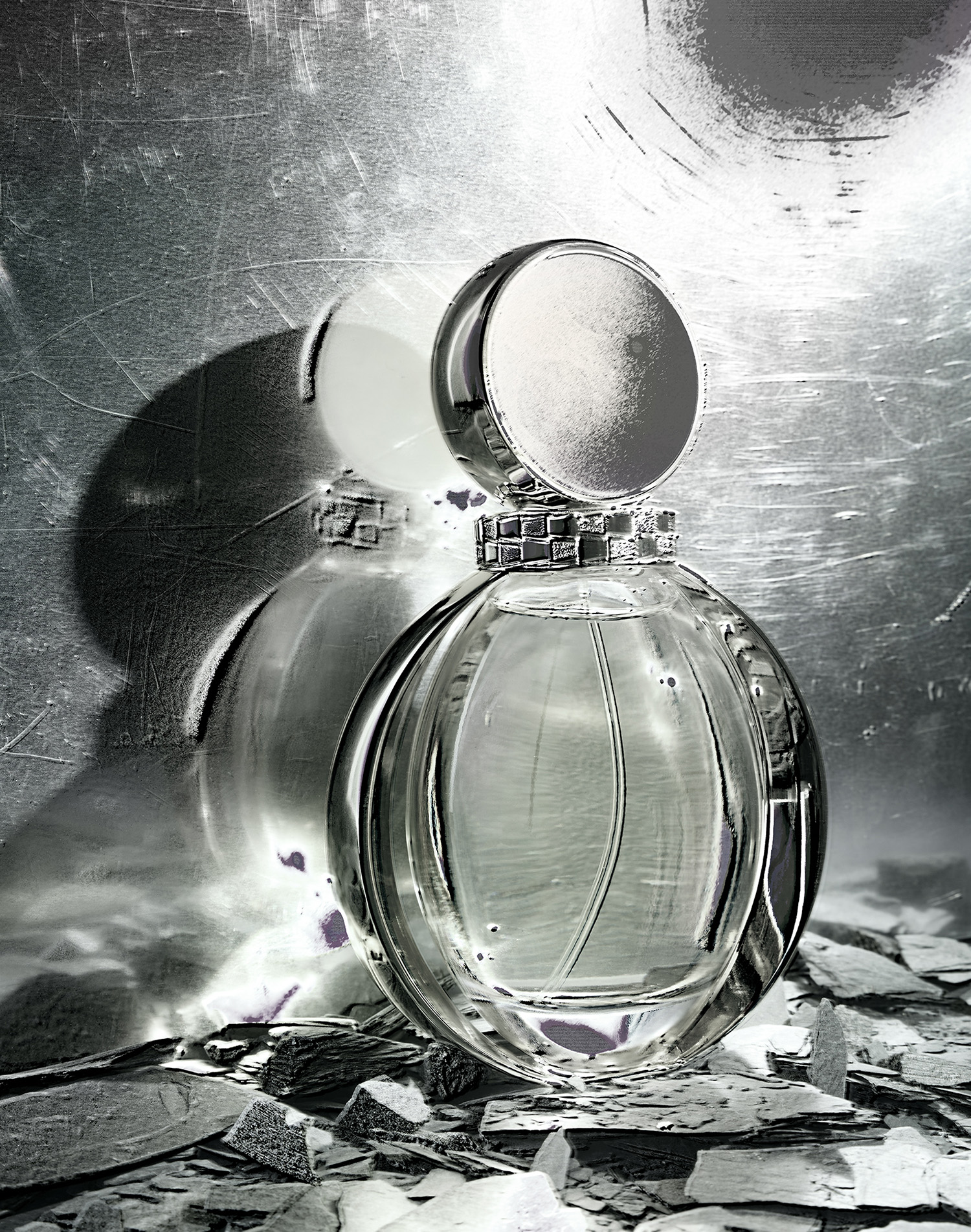 KMA photographer Daniel Schweizer photographs a grey bottle of perfume on grey rocks for Off The Wall