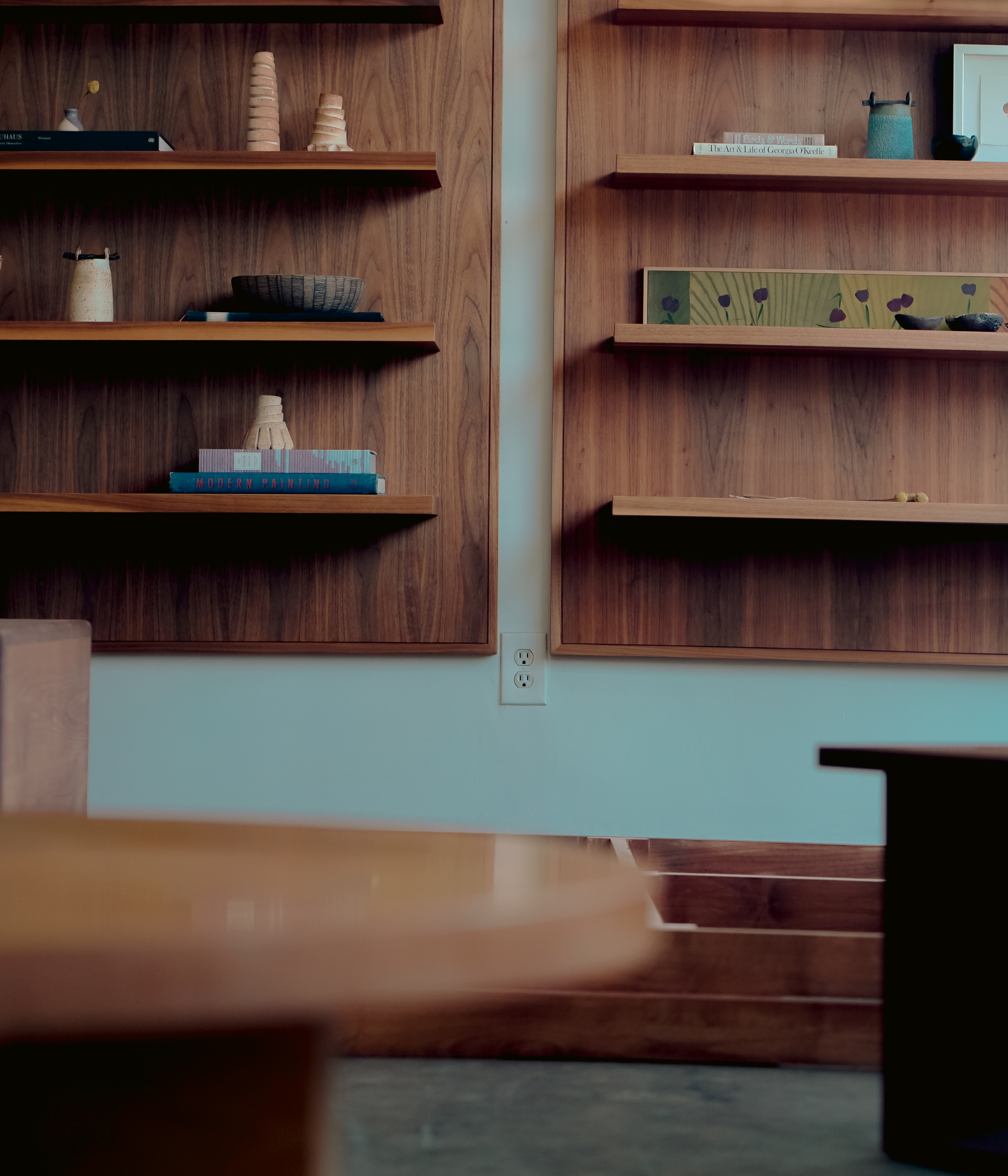 Leslie's wall shelves showcase gifts and objects designed by colleagues..