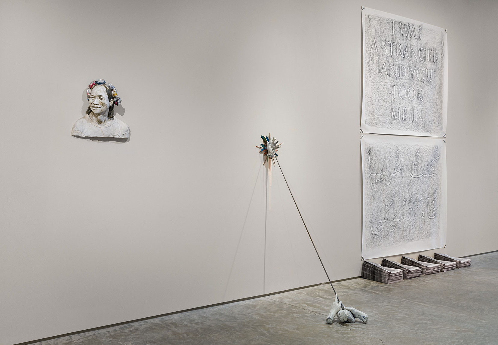 From left to right: John Ahearn, "Chin Chih with the Crown of Cans," 2013, acrylic on plaster with crushed cans, 18 x 19 x 8 inches; Dante Migone-Ojeda, "Longinus," 2023, cast stone, copper, epoxy clay, macaw feathers, copper chain, steel, 66 x 12 x 24 inches; Mierle Laderman Ukeles, "A Whole World," 1979/2023, from TOUCH SANITATION, Artist's Letter of Invitation Sent to Every Sanitation Worker with Performance Itinerary for 10 Sweeps in All 59 Districts in New York City, 1979 Page 2 of a 4 page printed brochure, 11 x 8 1/2 inches. Photo by Etienne Frossard. 