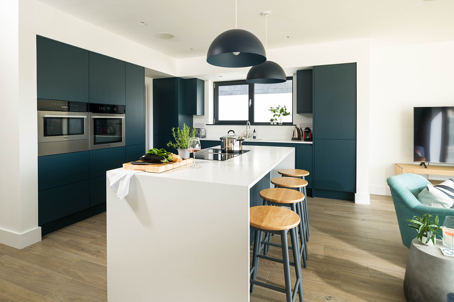 Modern kitchen area with central breakfast bar. Showed as part of slideshow.
