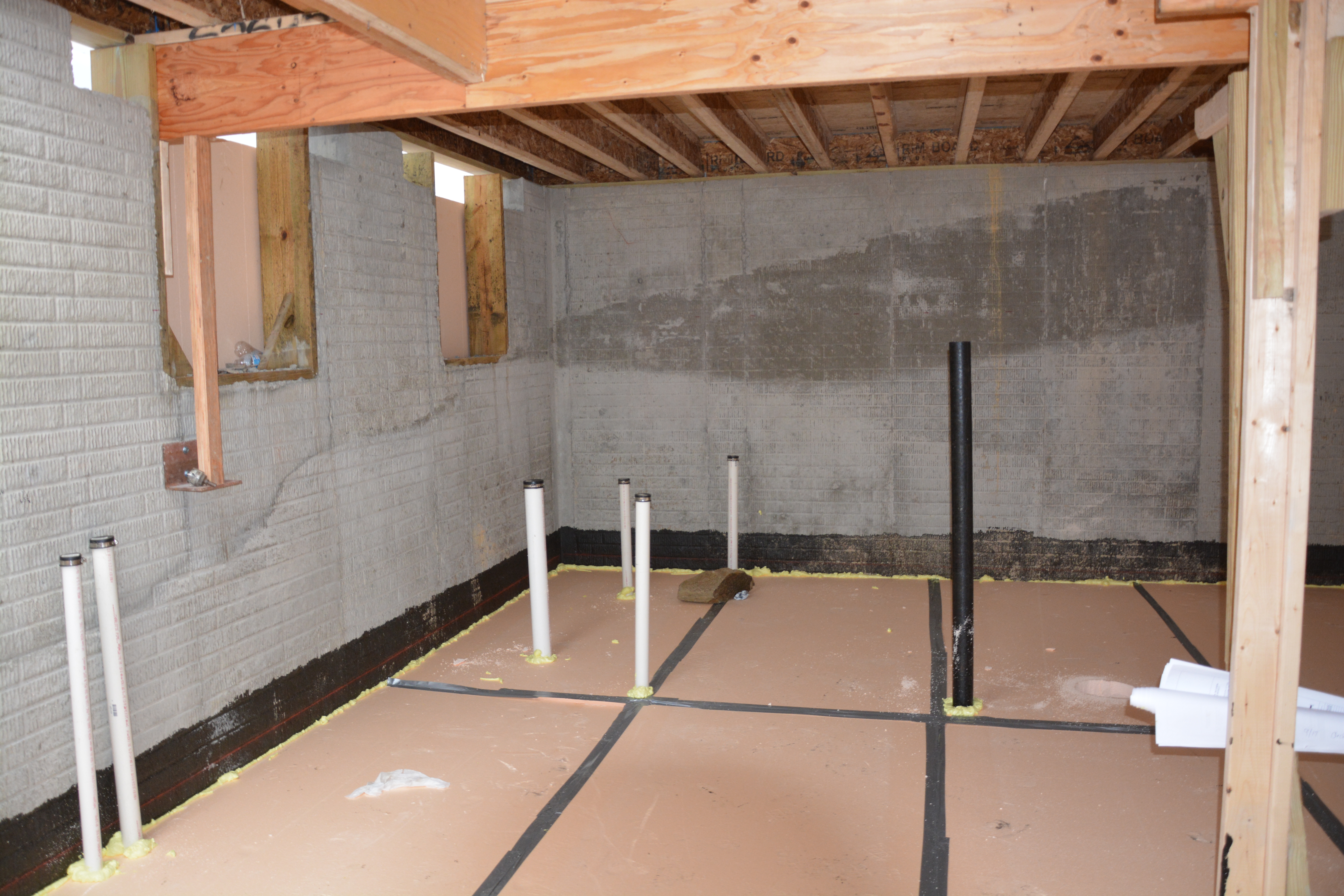 Construction image - insulation under the floor slab, taped and sealed to the perimeter walls