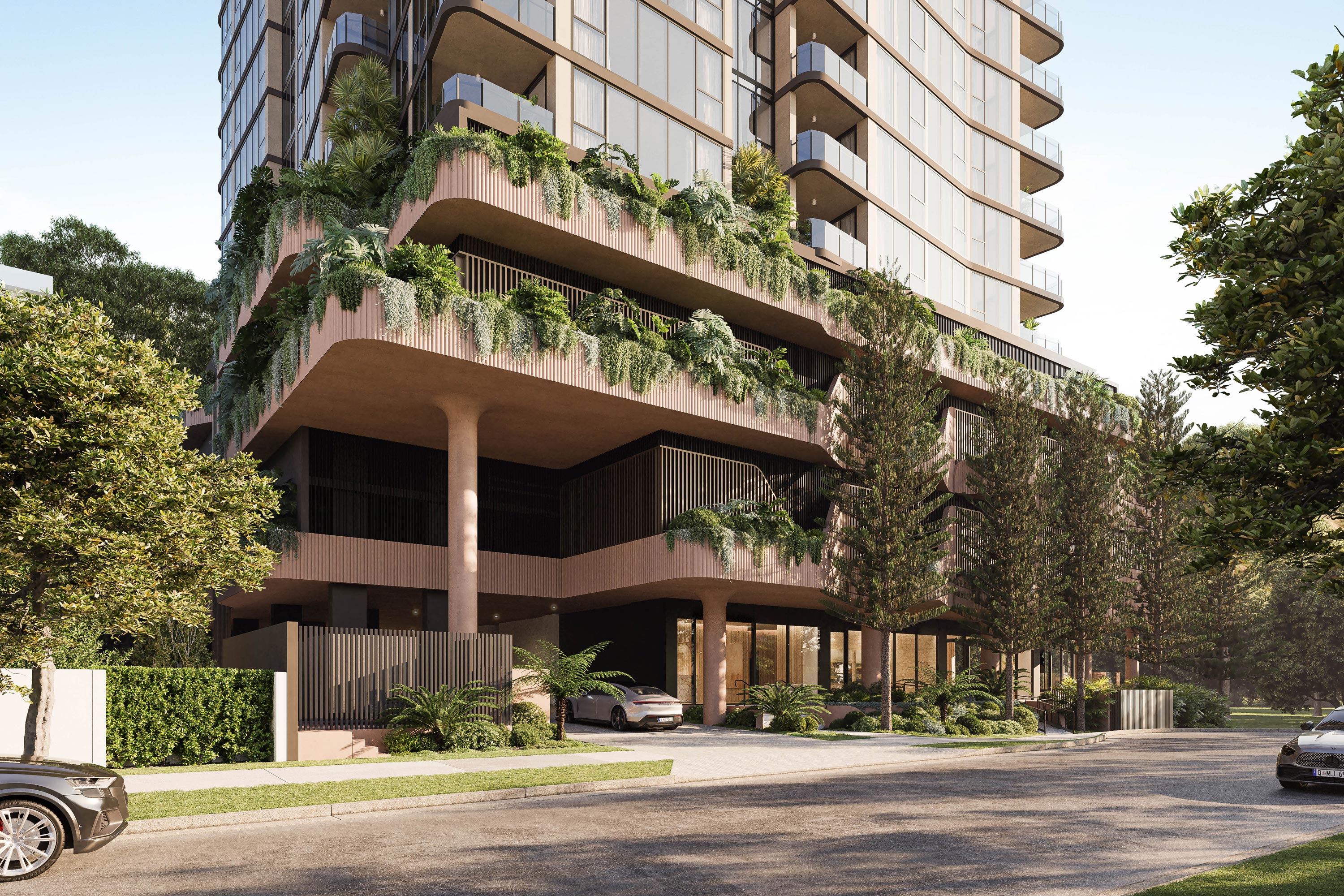 Street-level view of Florence Residences, highlighting the elevated, heavily landscaped podium with deep planter boxes overflowing with subtropical greenery and cascading vines. The podium’s curved, fluted soffits and slender circular columns create a permeable, open ground plane that seamlessly integrates with the mature trees of Cascade Gardens beyond, while concealing the car parking levels above.