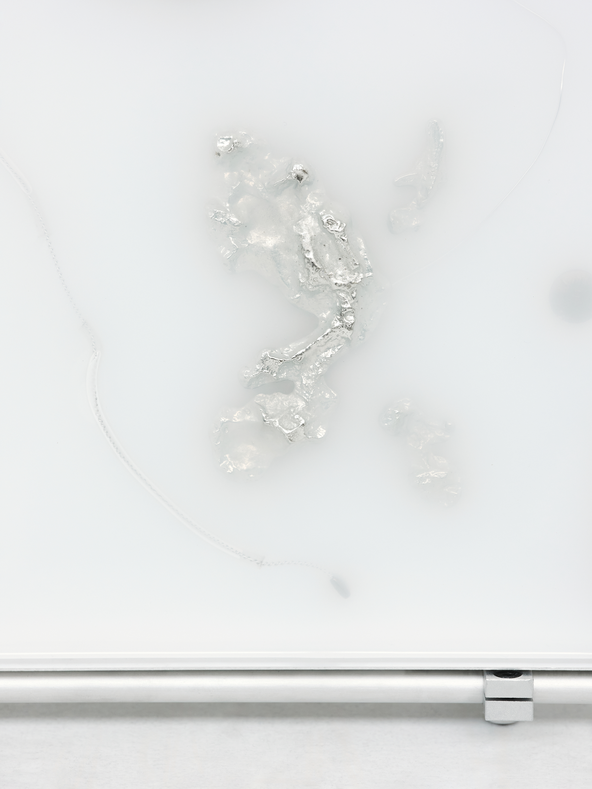 Imperma_97°58’28”N_34°29’47”E_  2025,  [61cm x 66cm x 10cm]  Art-O-Rama invited by Xxijra Hii Gallery, Marseille  Eco resin, aluminium, pewter, labels, found metal components and drain chain. 