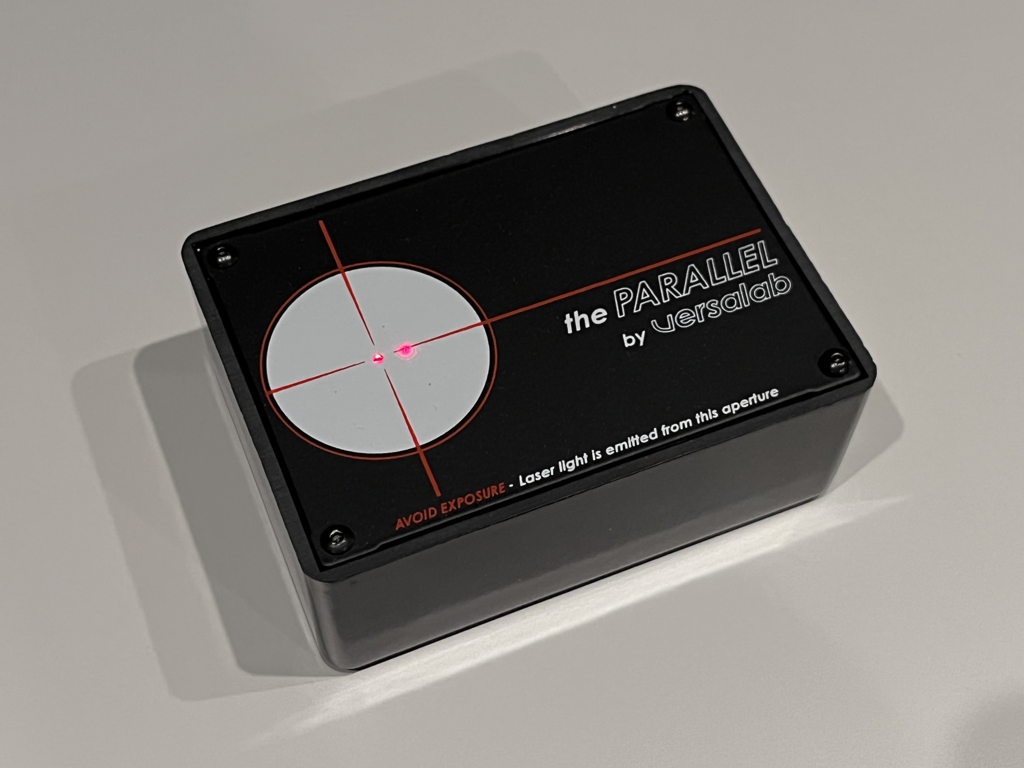 Left: The laser bounced off the lens and falls to the right of the center, indicating that the camera needed to swing to the left.