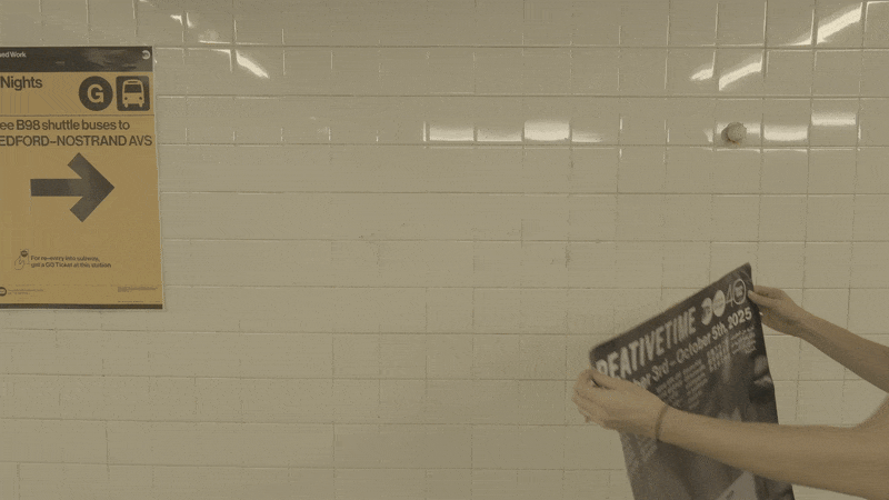 Project manager Amy Pekal installs poster