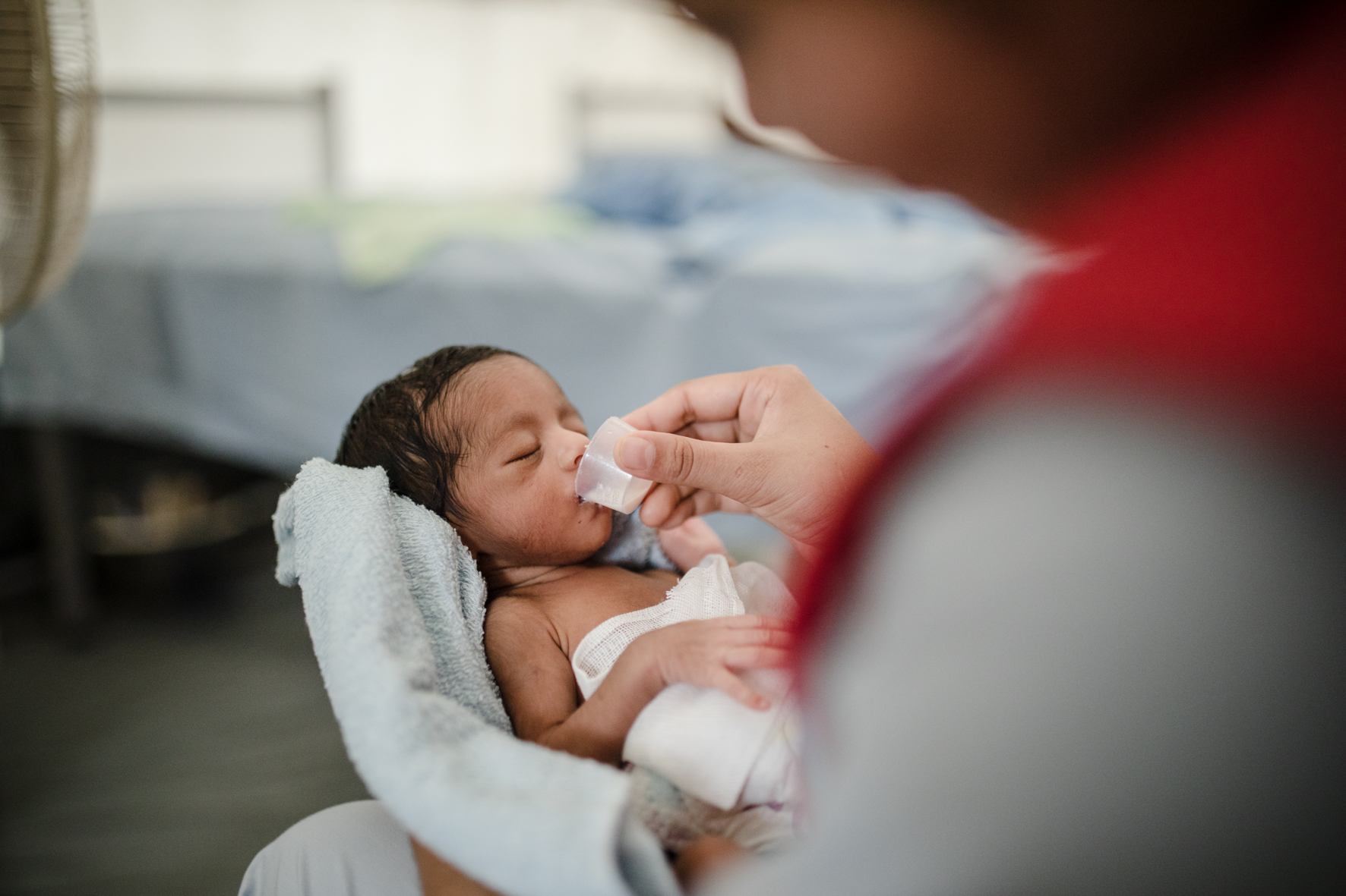 A day old twin being fed by a Red Crescent nurse in the Field Hospital. The mother of the twins, who already had three kids, didn't know that she was expecting two babies.