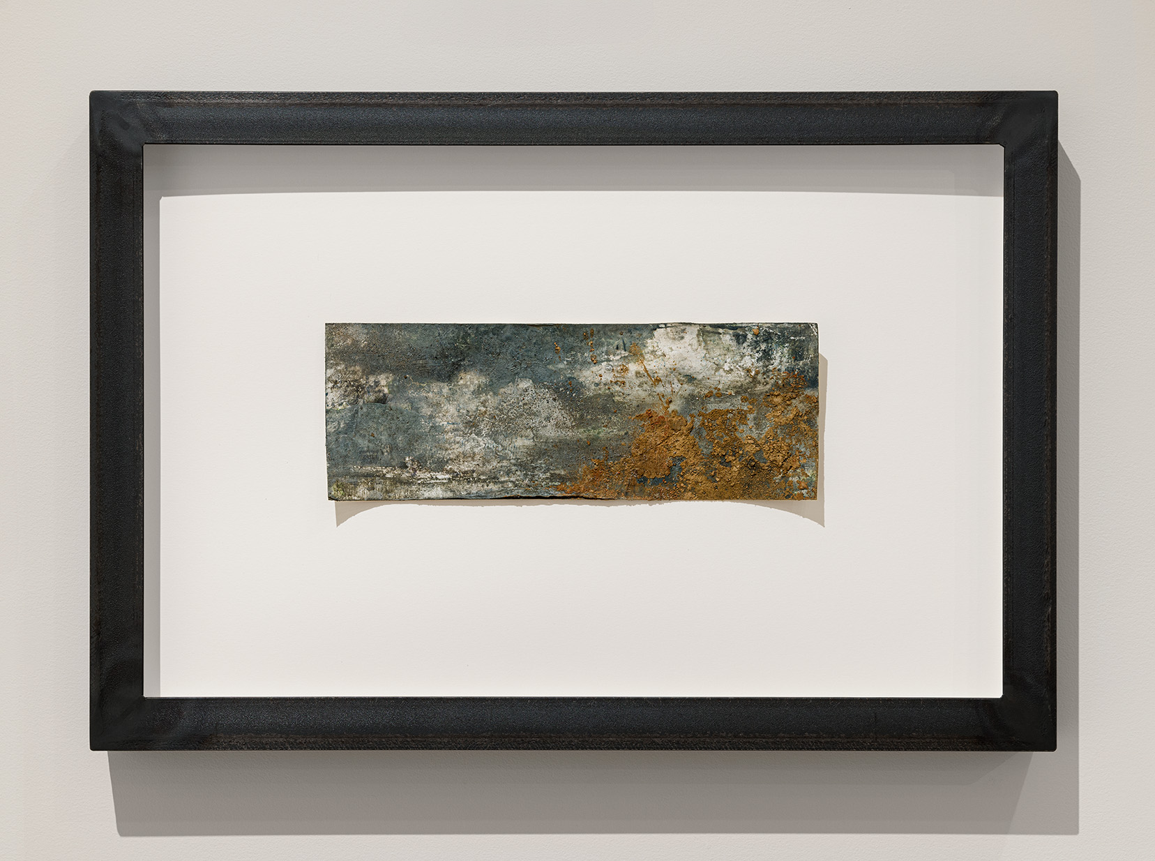 Athena LaTocha, "Untitled No. 20," 2022. Shellac ink, earth from the Green-Wood Cemetery, demolition sediment from a Brooklyn construction site, glass microbeads from New York City Department of Transportation on paper, custom raw steel artist frame, 18 1/2 x 27 x 2 inches. Photo by Etienne Frossard.