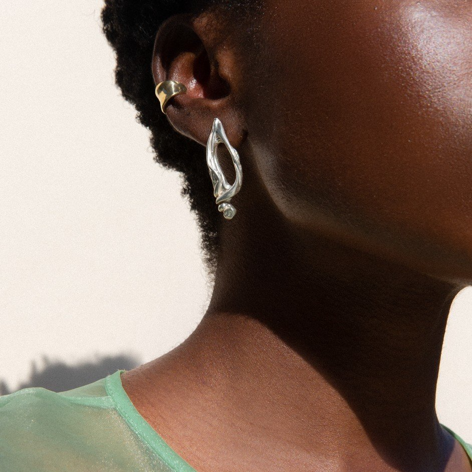 A model wears an earring and ear cuff by Laura Estrada Jewelry