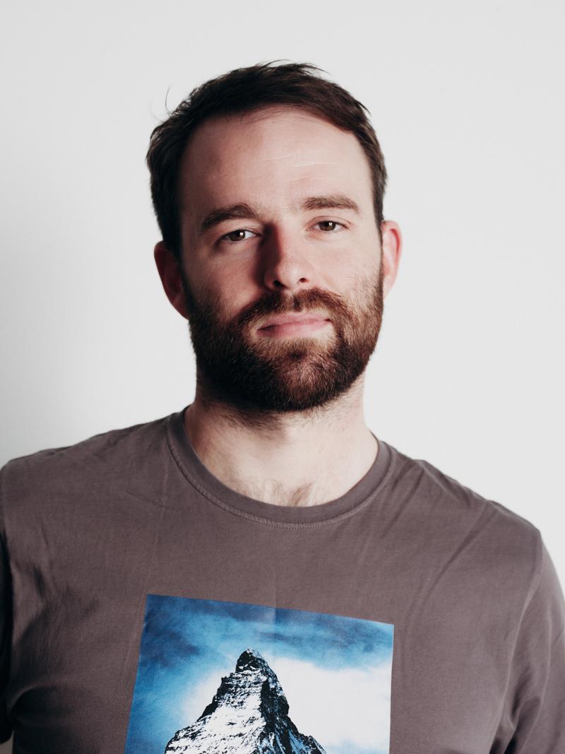 Conal O’Neill, Senior Operations & Business Development Manager at UP! Productions, wearing a grey t-shirt with a mountain print.