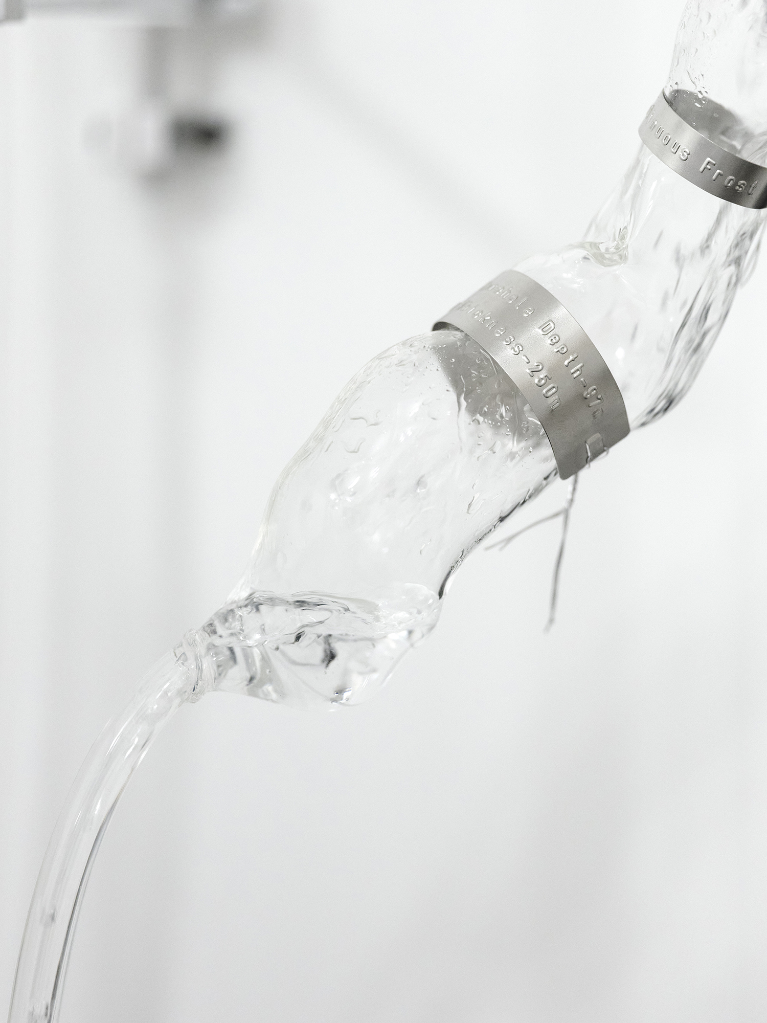 Soft Water, 2025,  [2m x 70cm x 40cm],  Spillâge [Curated by Haze Projects] Standpoint Gallery, London  Glass, water, plastic tank, aluminium, labels, pump, metal components and drain chain 