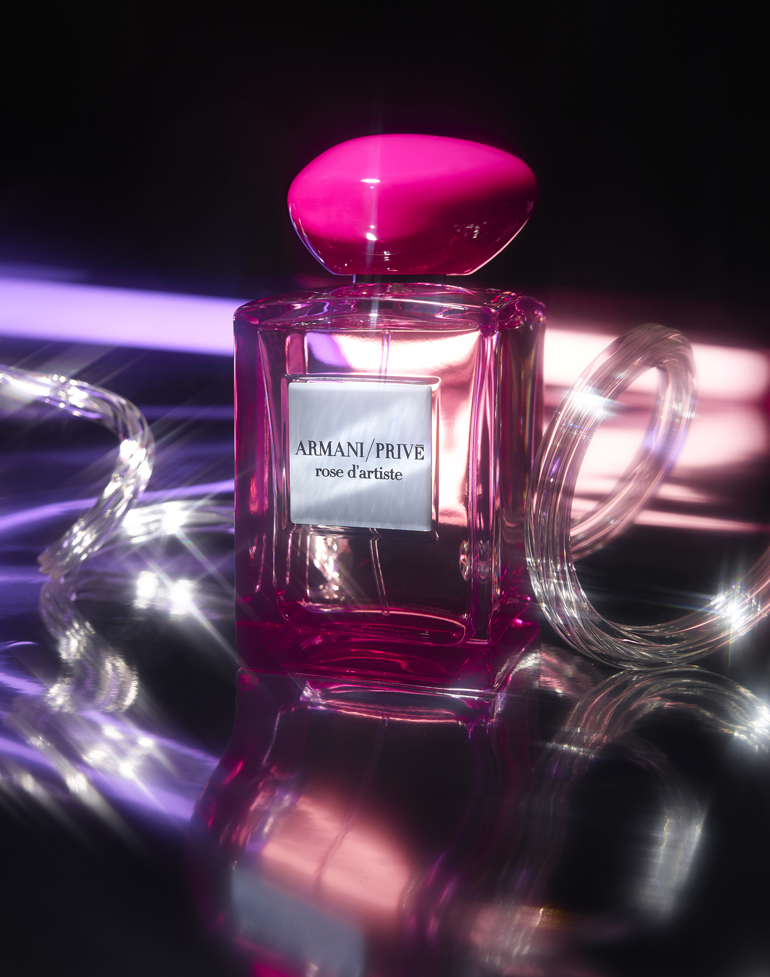 KMA photographer Daniel Schweizer shoots a photo of a pink perfume bottle sitting on a mirror for French Magazine