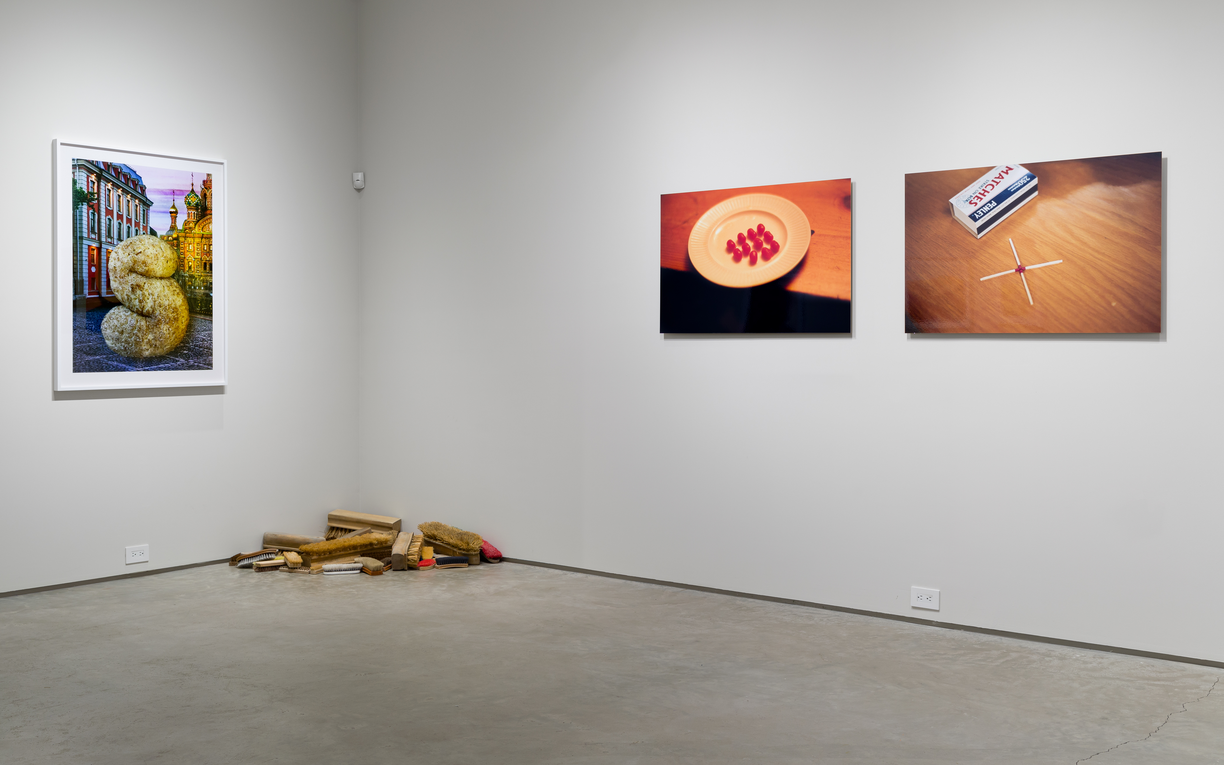 From left: Nina Katchadourian, "Giant S (Large)," 2019 ("Seat Assignment" project, 2010 and ongoing), C-print, Edition of 8 + 2AP; edition X/8, 45 1/2 x 35 1/2 inches. Robert Therrien, "No Title (scrub brushes)," 1993-2000, wood and straw, dimensions variable. Rivane Neuenschwander, "Conversation 8," 2002, C-print on aluminum, 26 x 40 inches. Rivane Neuenschwander, "Conversation 5," 2002, C-print on aluminum, 26 x 40 inches.