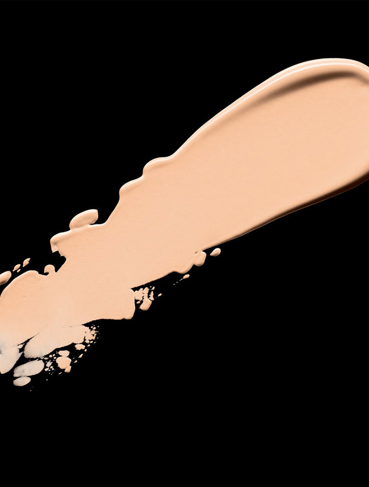 KMA stylist Rachel Haas designs set for texture photo of smeared tan concealer on black background for Gucci