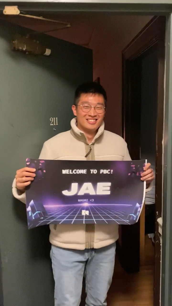 Jae holding a sign that welcomes him to PBC
