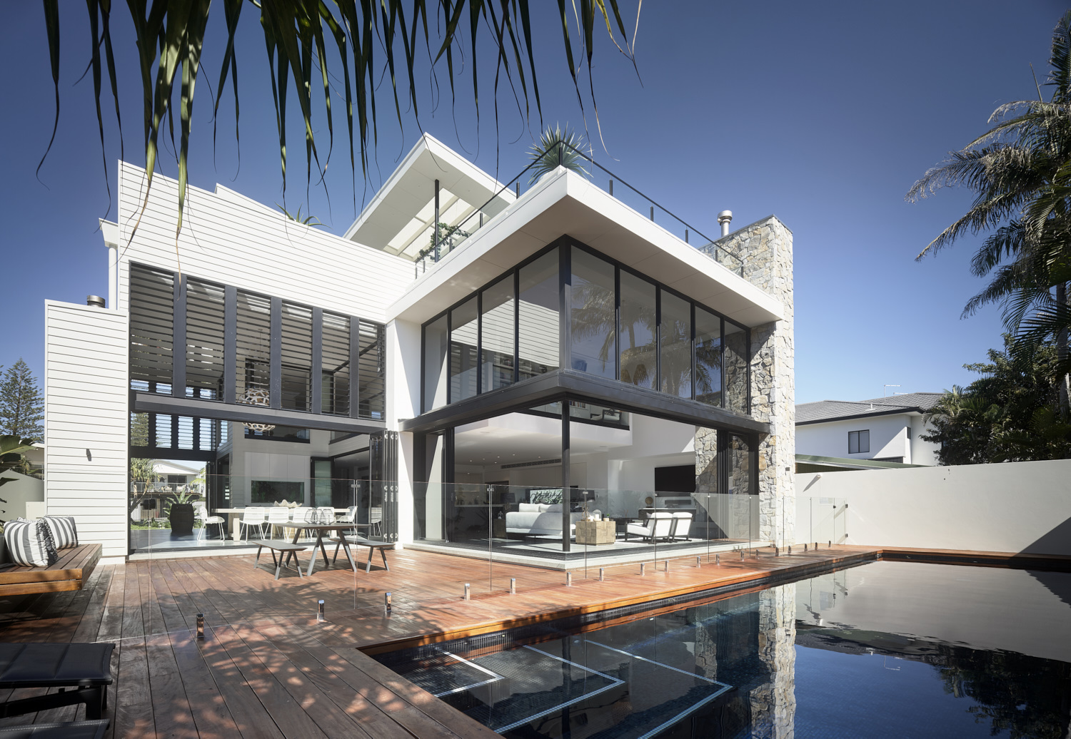 A contemporary house with a pool and deck, showcasing modern architecture and outdoor living space.