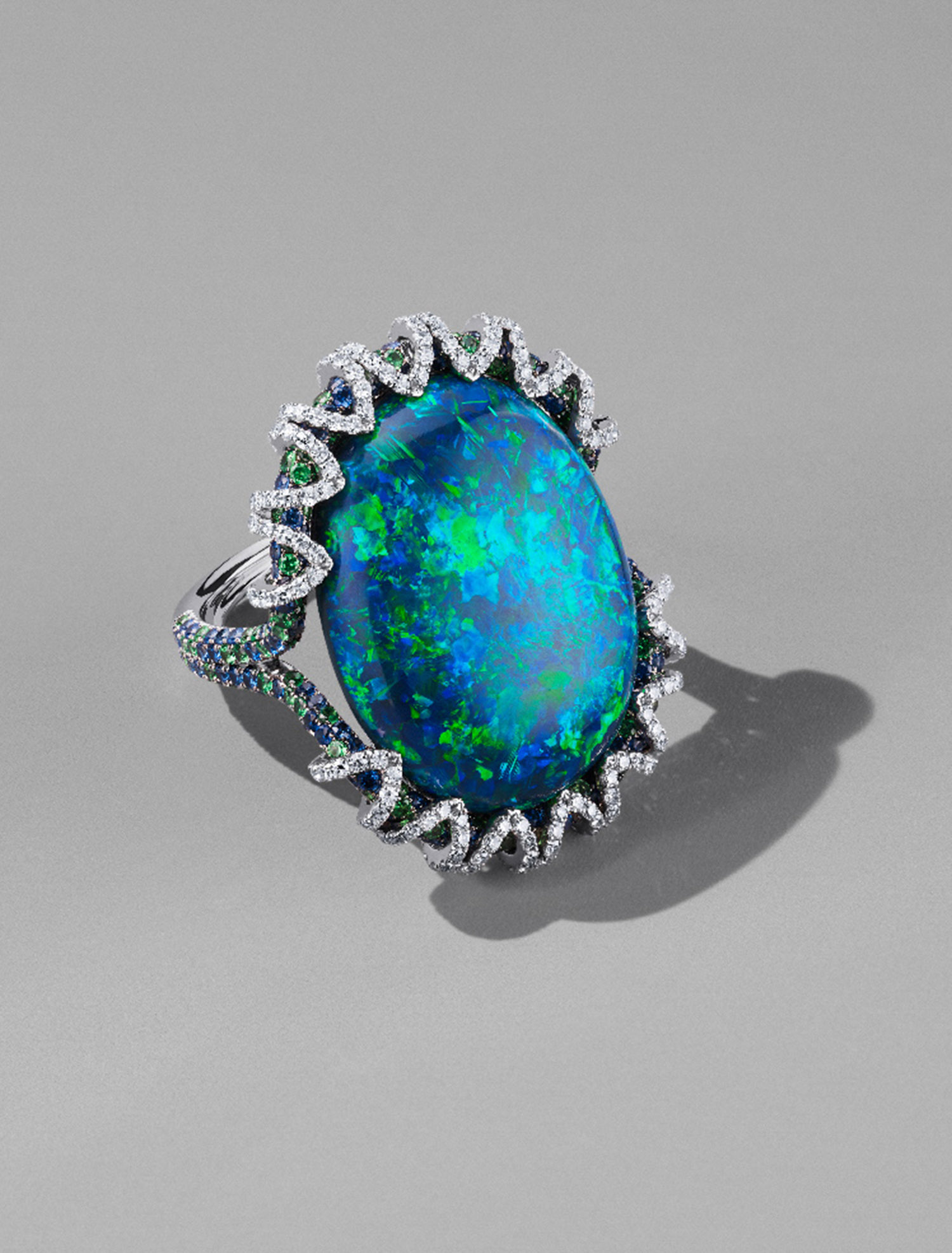 KMA stylist Sara Wacksman designs set for a photo of bright opal and diamond ring on a gray background for Bergdorf Goodman