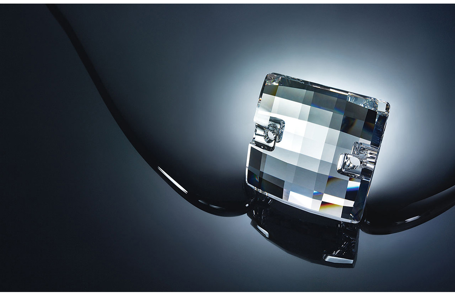 KMA photographer Daniel Schweizer photographs a big bright diamond ring for Swarovski against a grey dripping background