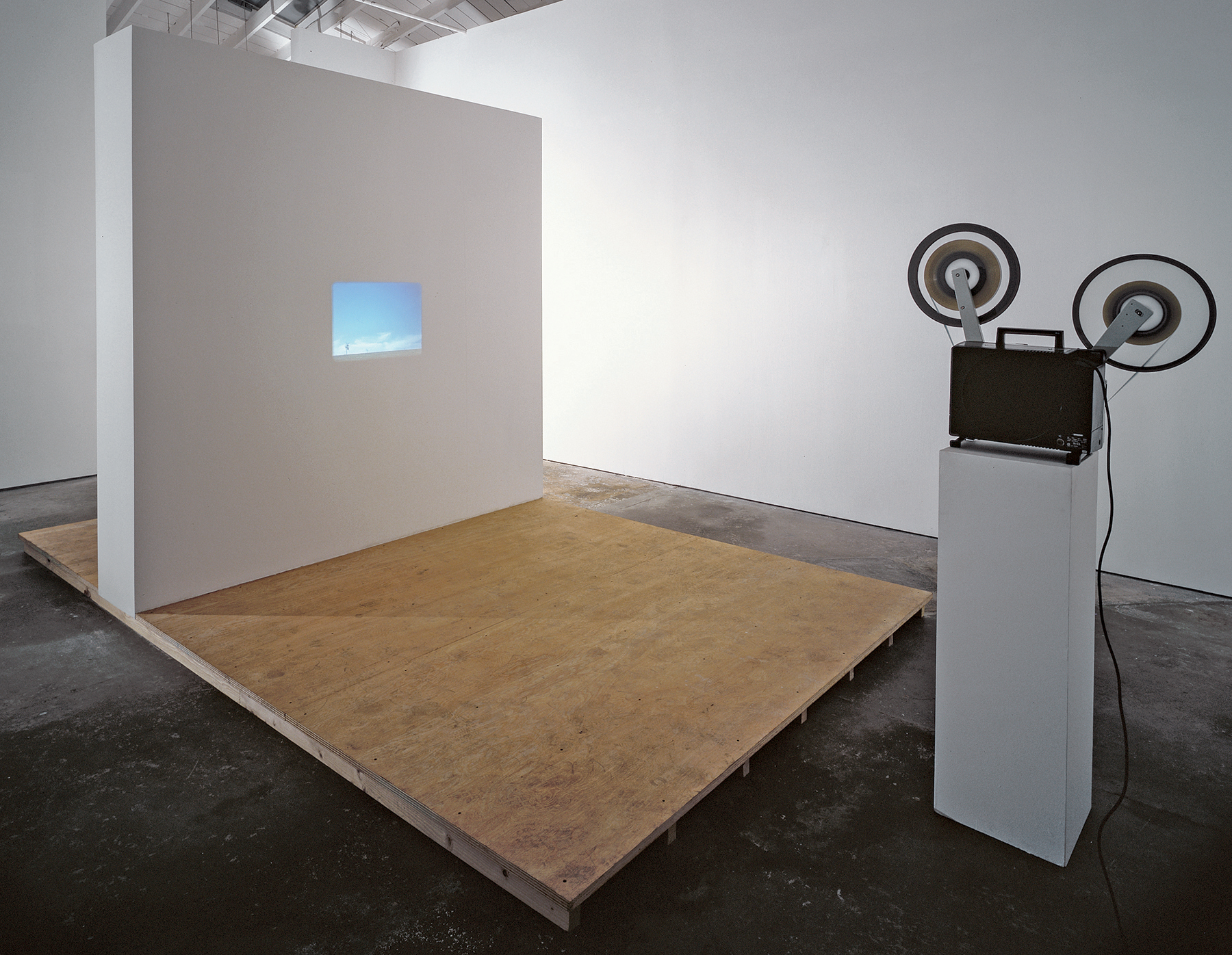 Untitled Sculpture, 1999. Seven photographs, one 16mm film, projector, wood and plasterboard exhibition structure. Dimensions variable