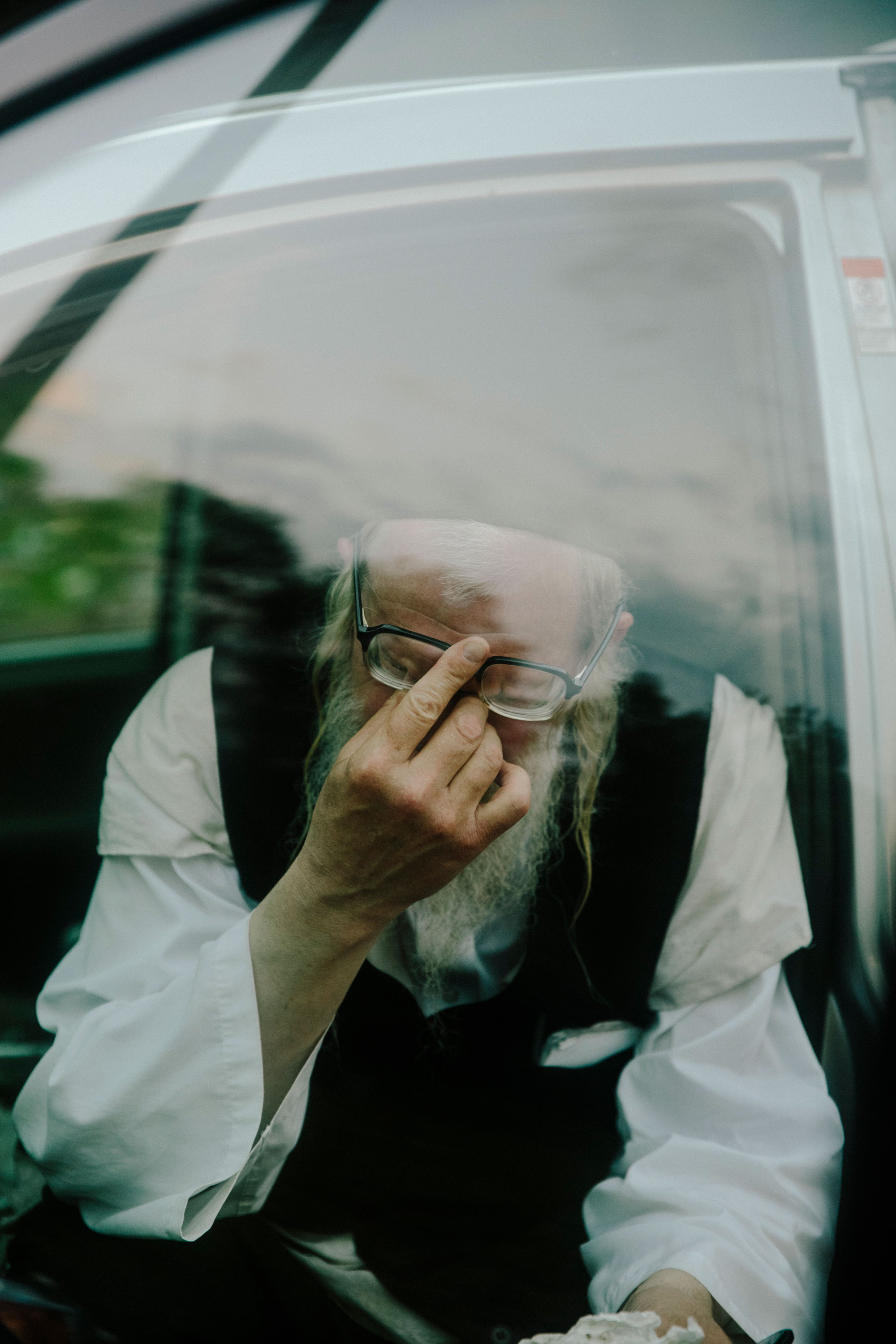 Rabbi Yakov Kellner rests after burying of a COVID-19 victim in Woodridge. Kellner said he felt overwhelmed after burying the man, whose body had been kept in a freezer for a month. “Took me two days and nights to get back to myself,” he said.