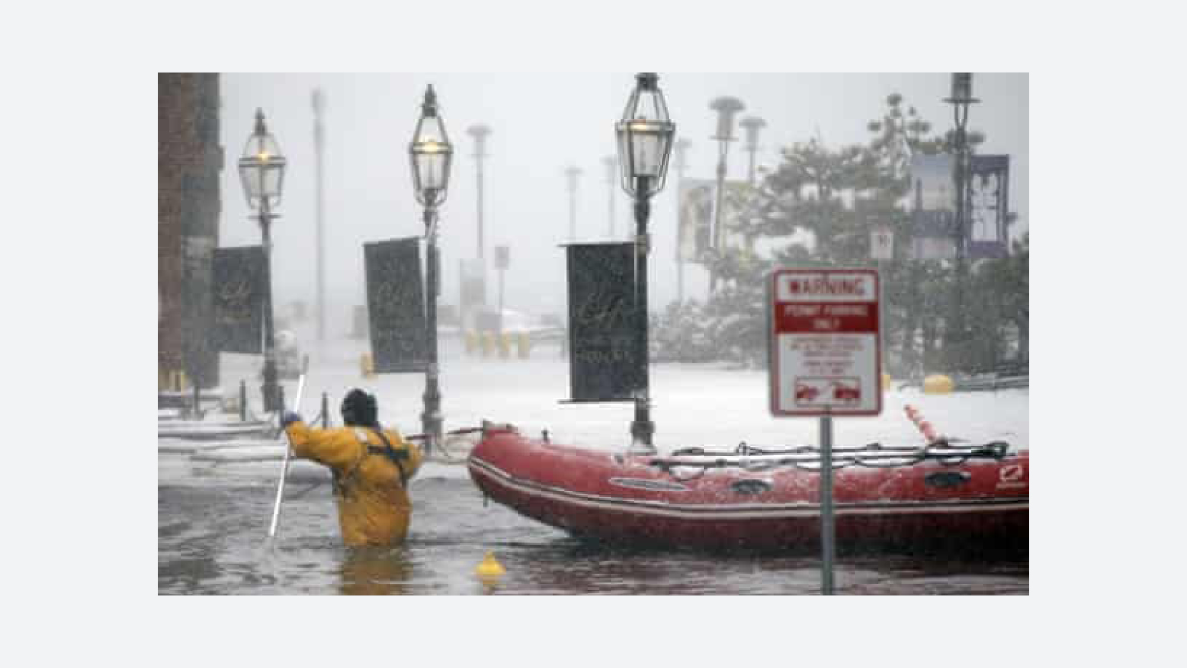 Fig. 56 Firefighter wading through stormwater at Long Wharf in East Boston, Associated Press