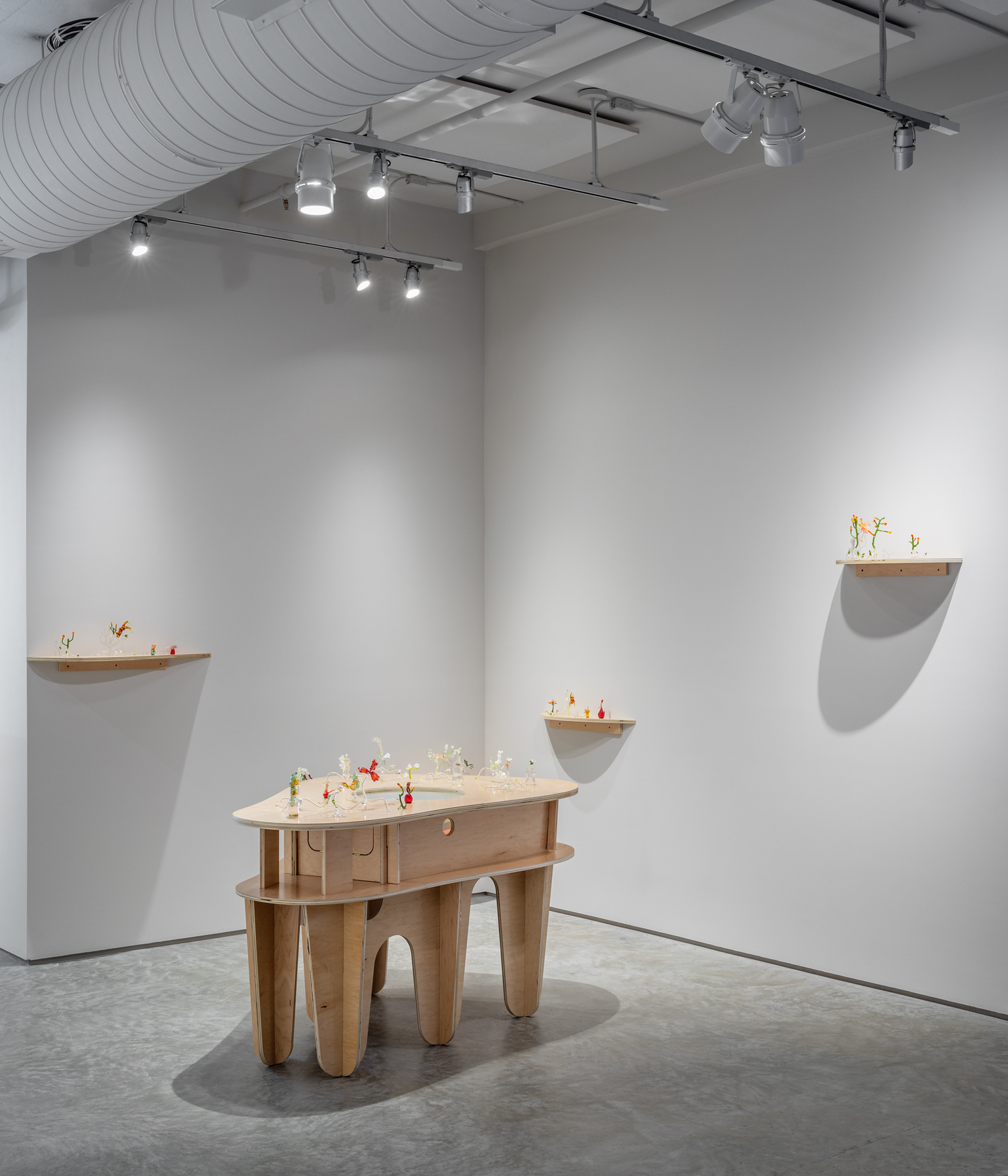 Goldie Poblador, "Fertility Flowers," 2021, handblown glass, scent, maple wood pedestal, pico projector.