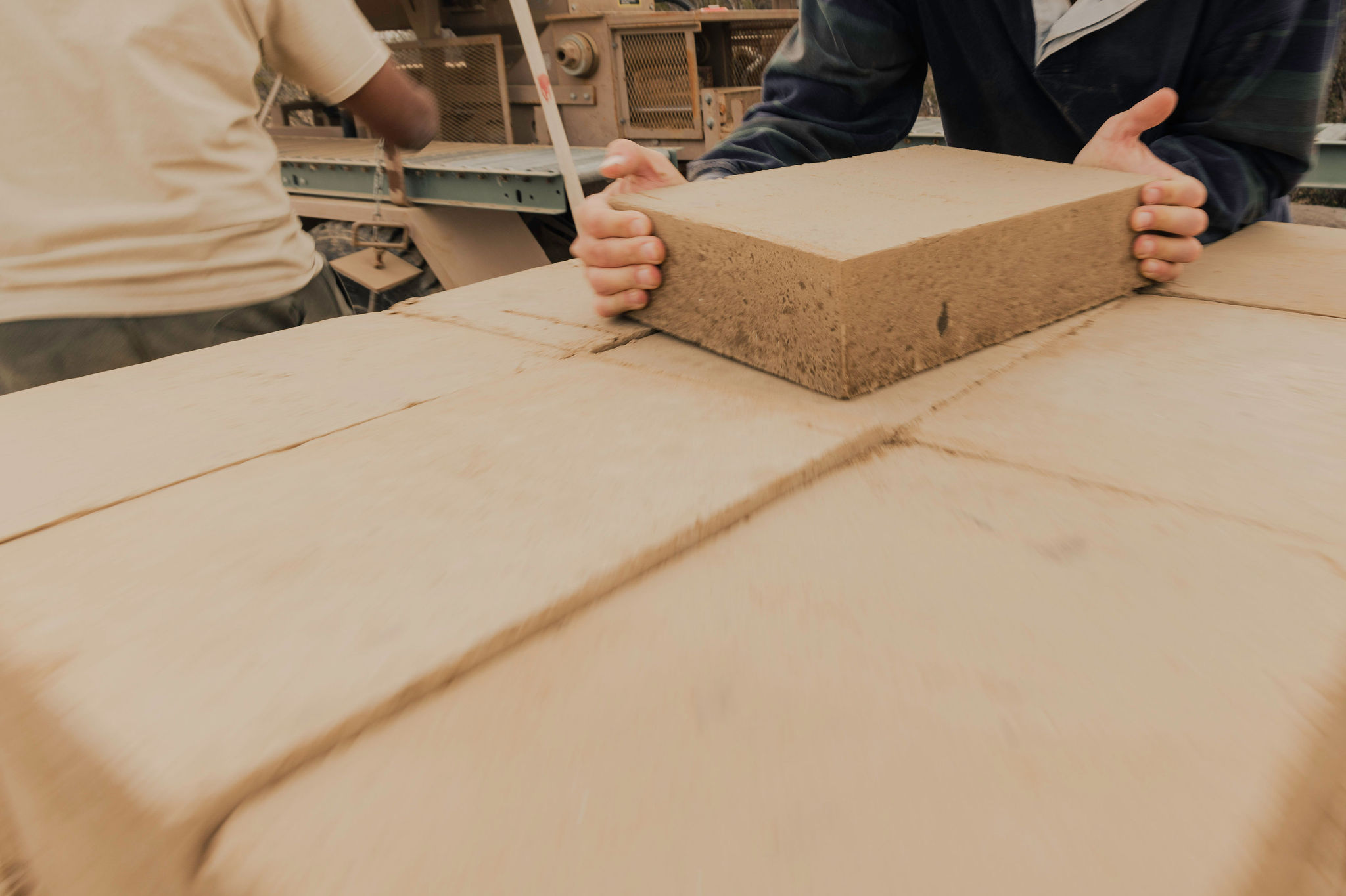A damp mix of inorganic subsoil including clay and aggregate is compressed at high pressure to form blocks using a mechanical press. Blocks may be stabilized with lime or portland cement. Typically, around 1500 - 2000 psi is applied in compression. The compression strength of properly made CEB can meet or exceed that of typical cement or mud brick. Blocks may be shaped to accommodate rebar.