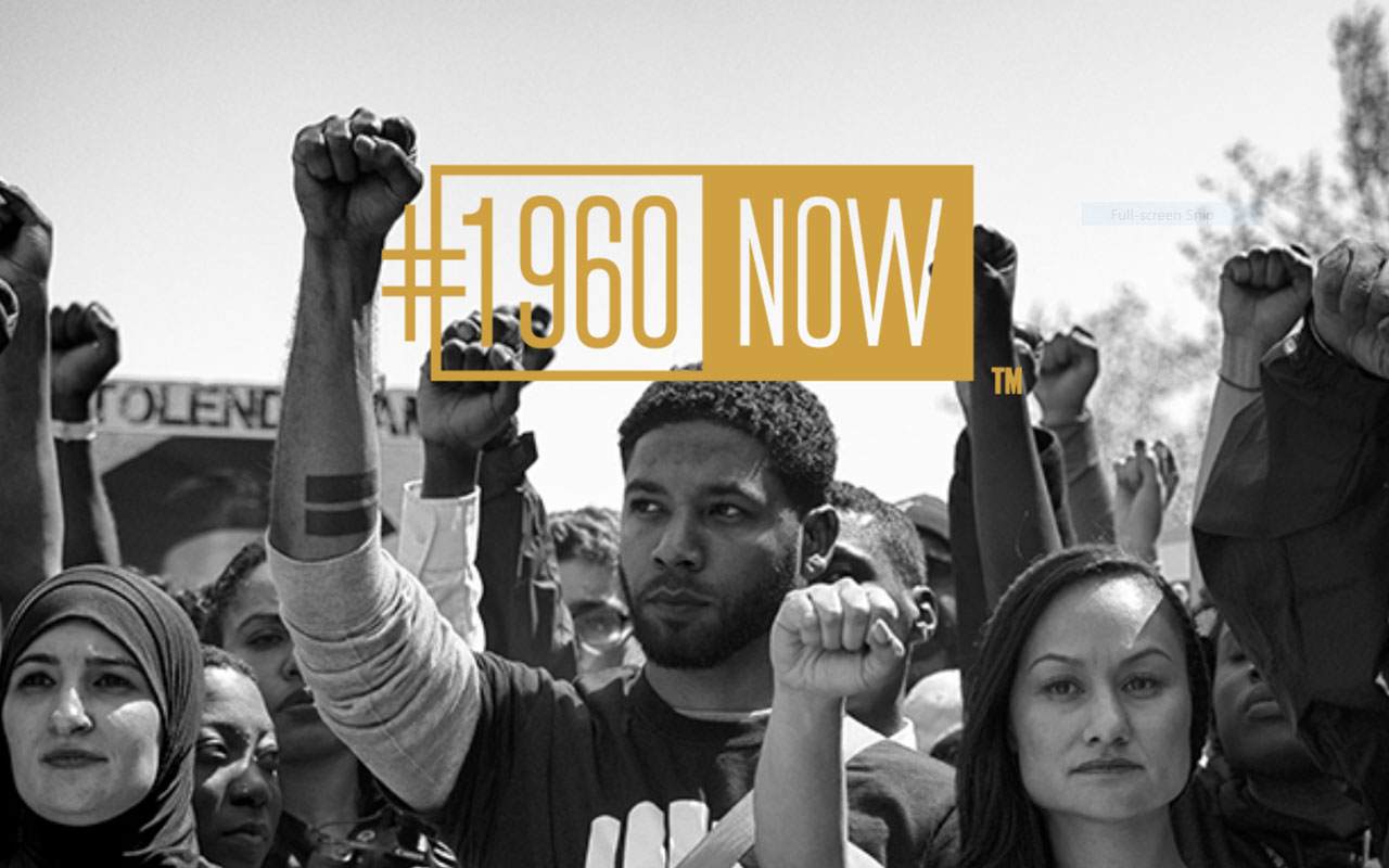 Black and white protest image by Sheila Pree Bright with the #1960Now gold logo.