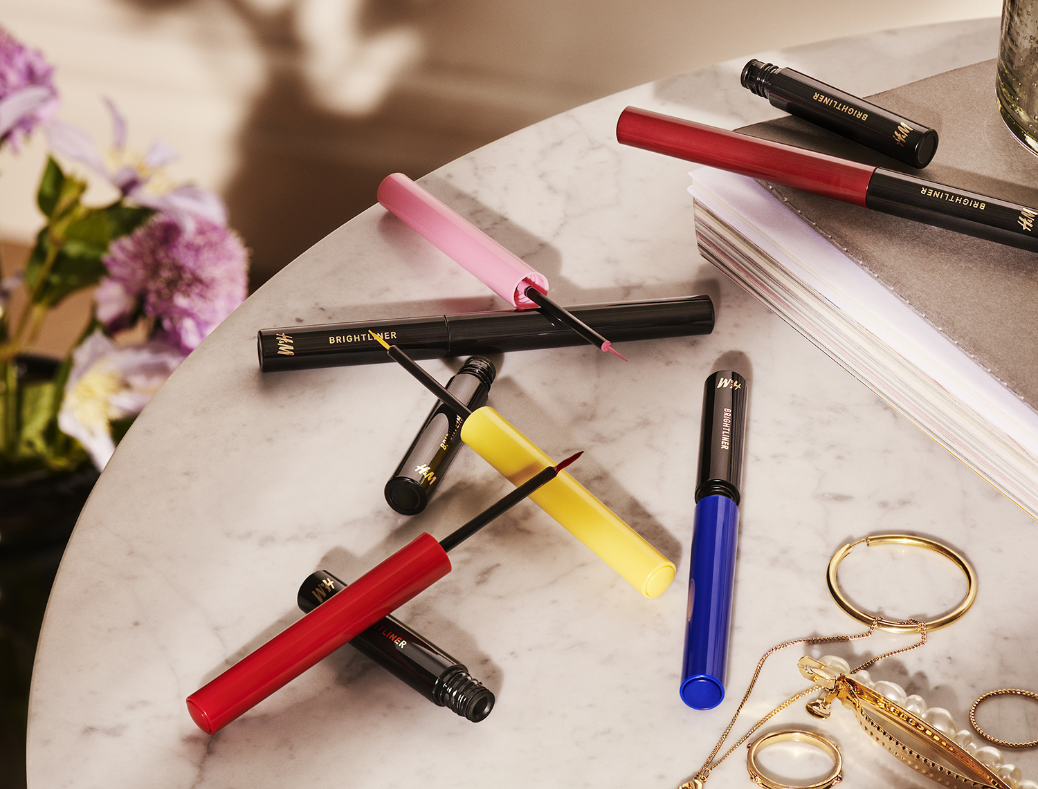 Bright colored eyeliner is artistically displayed for H&M Beauty, shot by Still Life Photographer Martin Vallin