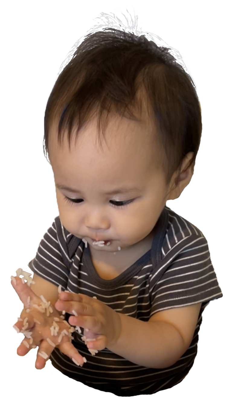 Baby Biển with rice sticking all over his hands and face - son of the web designer