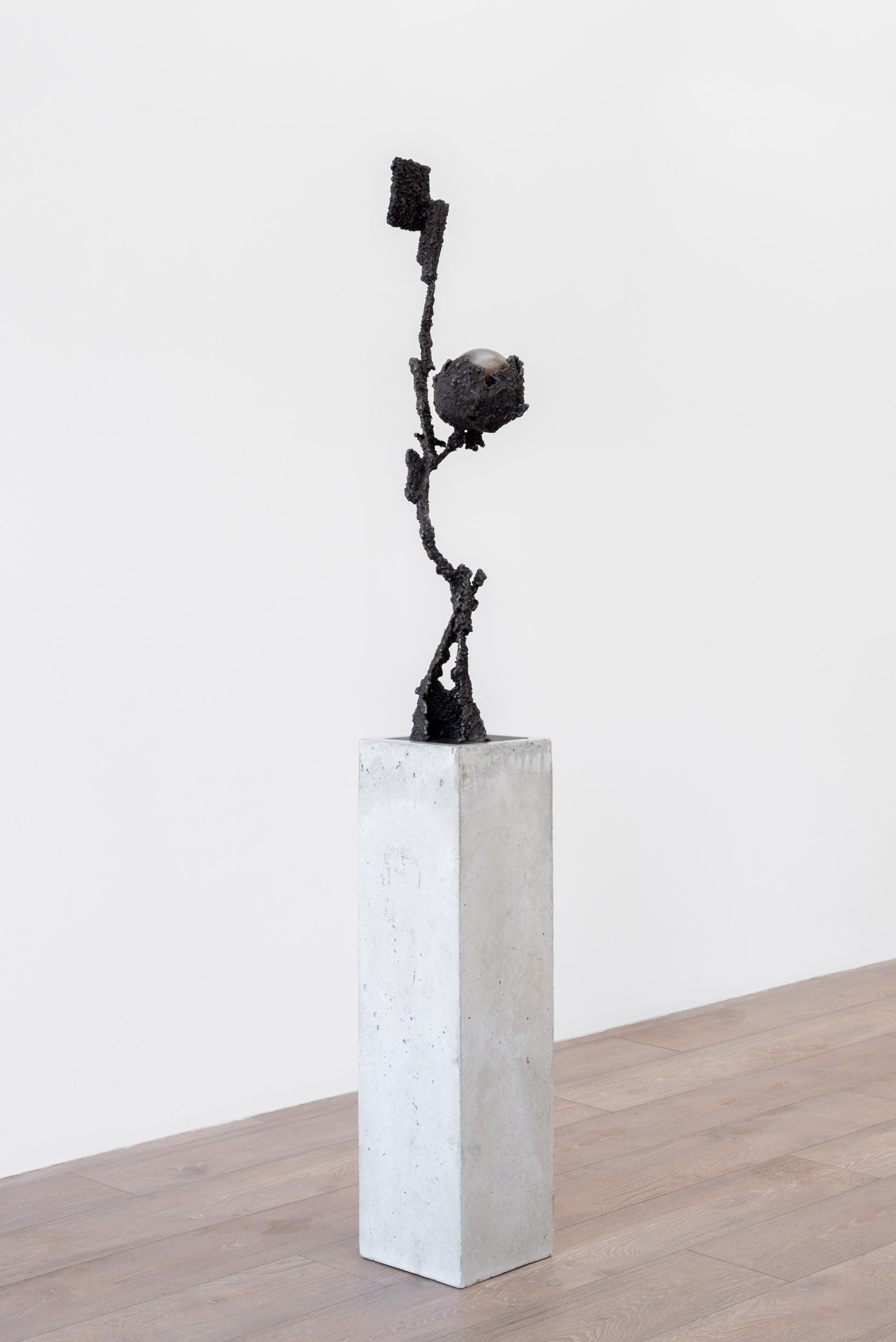 Ronan Stewart, Husk (G), 2025, 34” x9” x 8” / 86.5cm x 23cm x 20cm, steel; Plinth: 30” x 8” x 8” / 76cm x 20.5cm x 20.5cm, portland cement, sand, pea gravel, fibreglass shards.