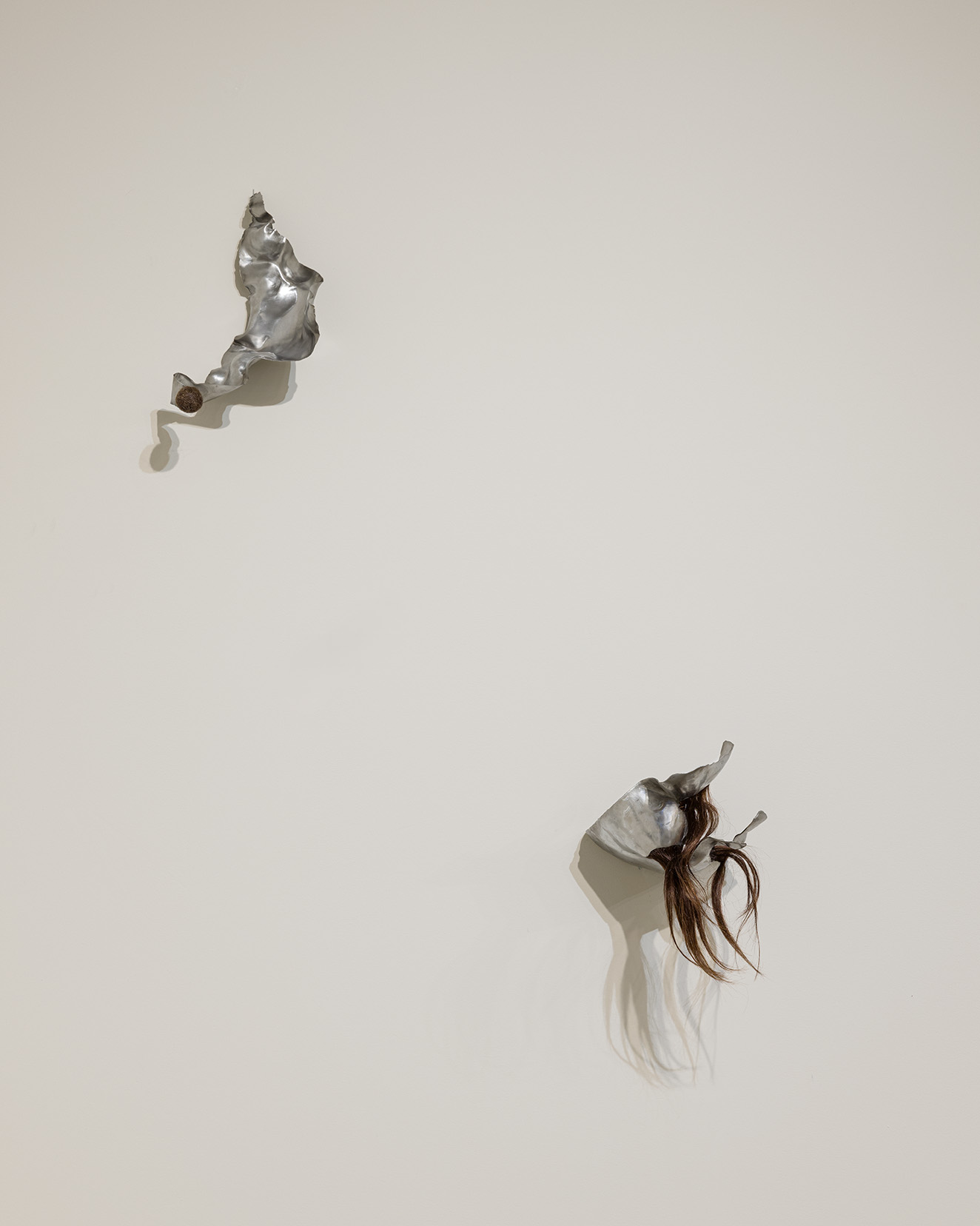 (Left) Magdalena Dukiewicz, Object #2 , 2022. Artist’s hair, steel, 13 x 7 x 5 inches.  (Right) Magdalena Dukiewicz, Object #1, 2022.  Artist’s hair, steel, 11 x 8 x 8 inches. Photo by Etienne Frossard.