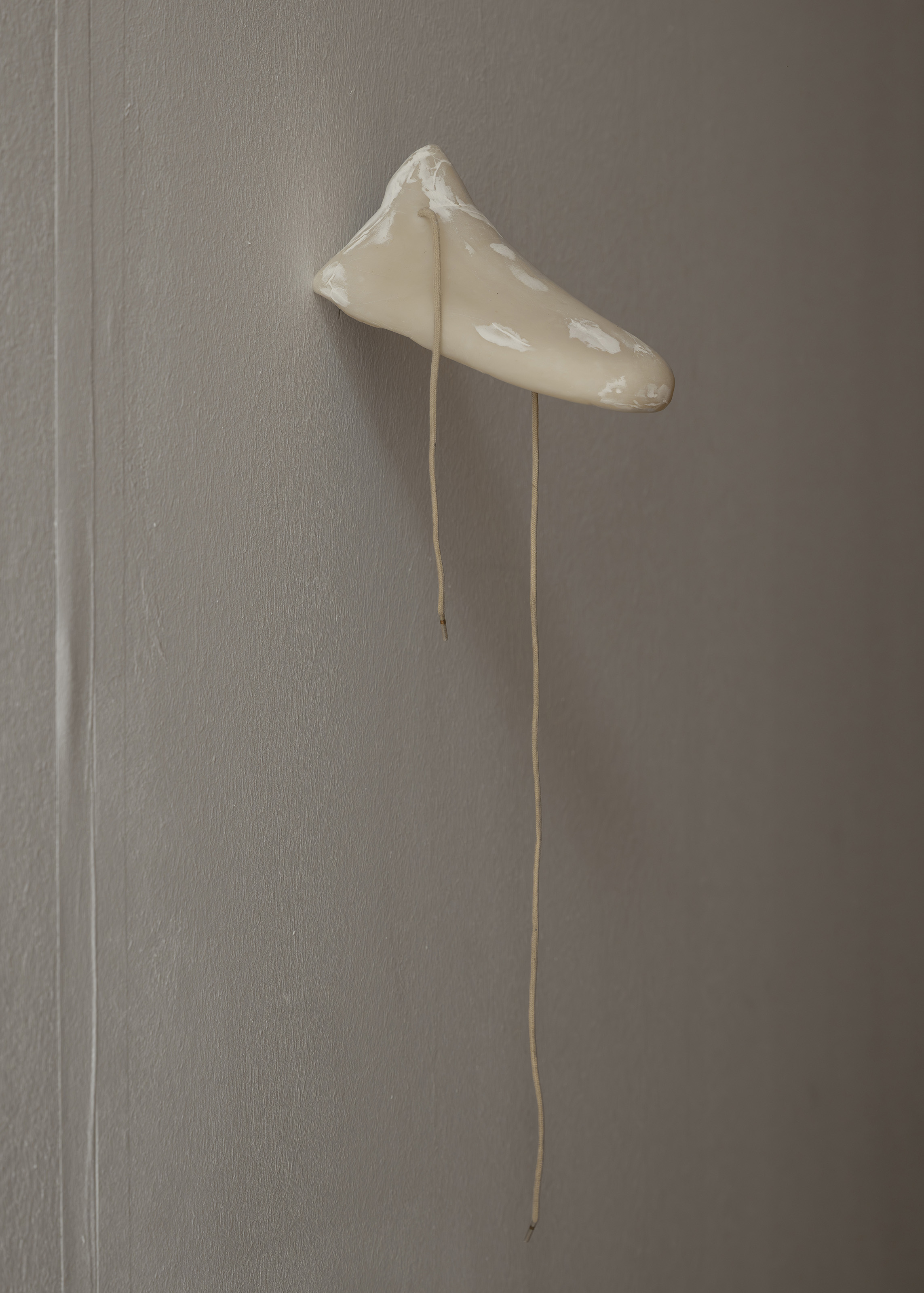 Bystander (Right), 2025. Air-dry porcelain, wood filler, shoe lace. 8 x 16,5 x 7,5 cm