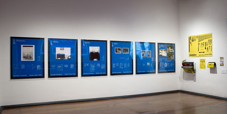 Mick Hender and Lucas Ihlein, The Blue Panels, Silver Artrage Festival History Exhibition, 2008. To the right of the blue panels in this installation shot is a fragment from Mick Hender's Black and Gold Art project from 1995