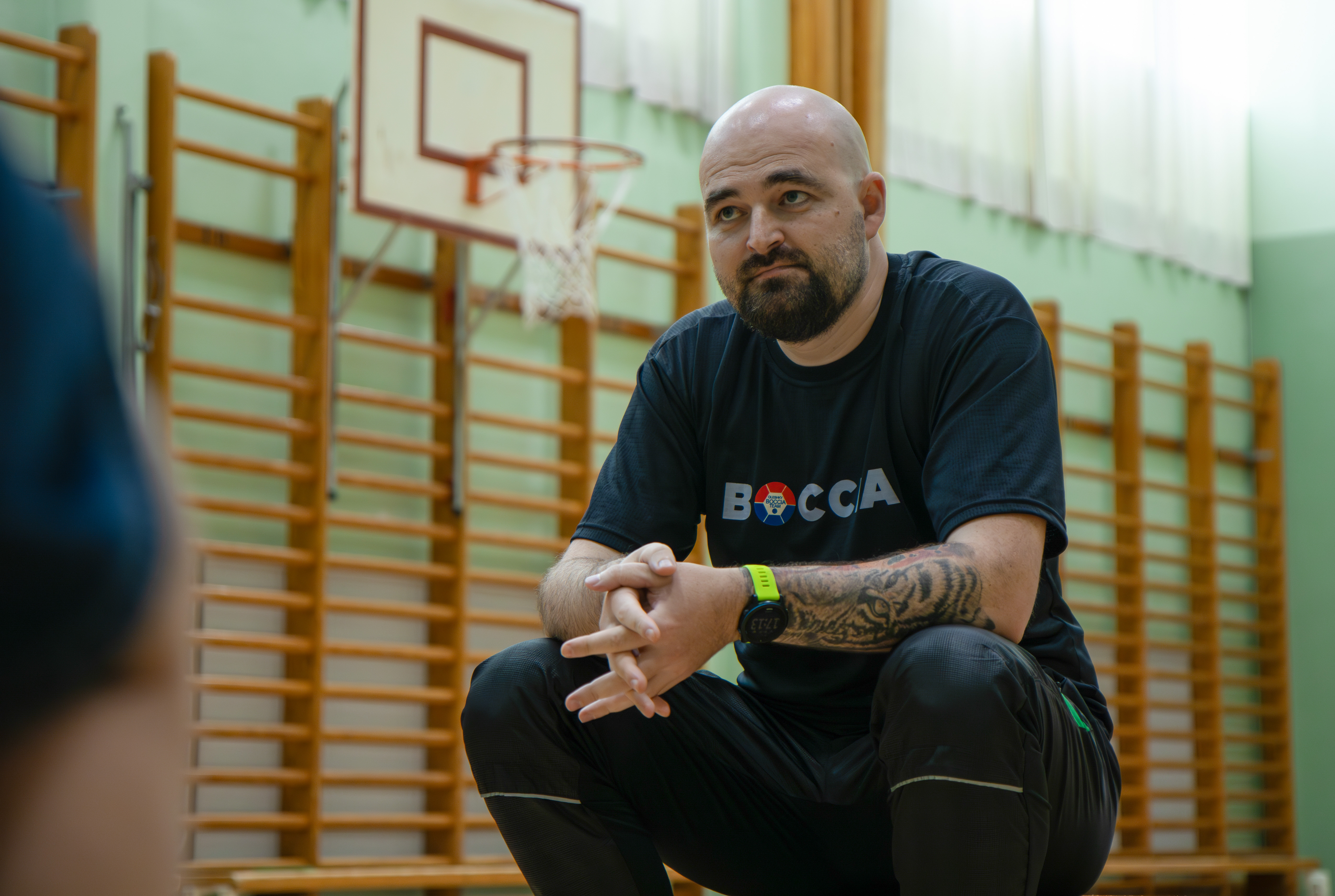 Vadym Reutsky, a teacher and sports coach at the school, is in the gym of the school near his home.