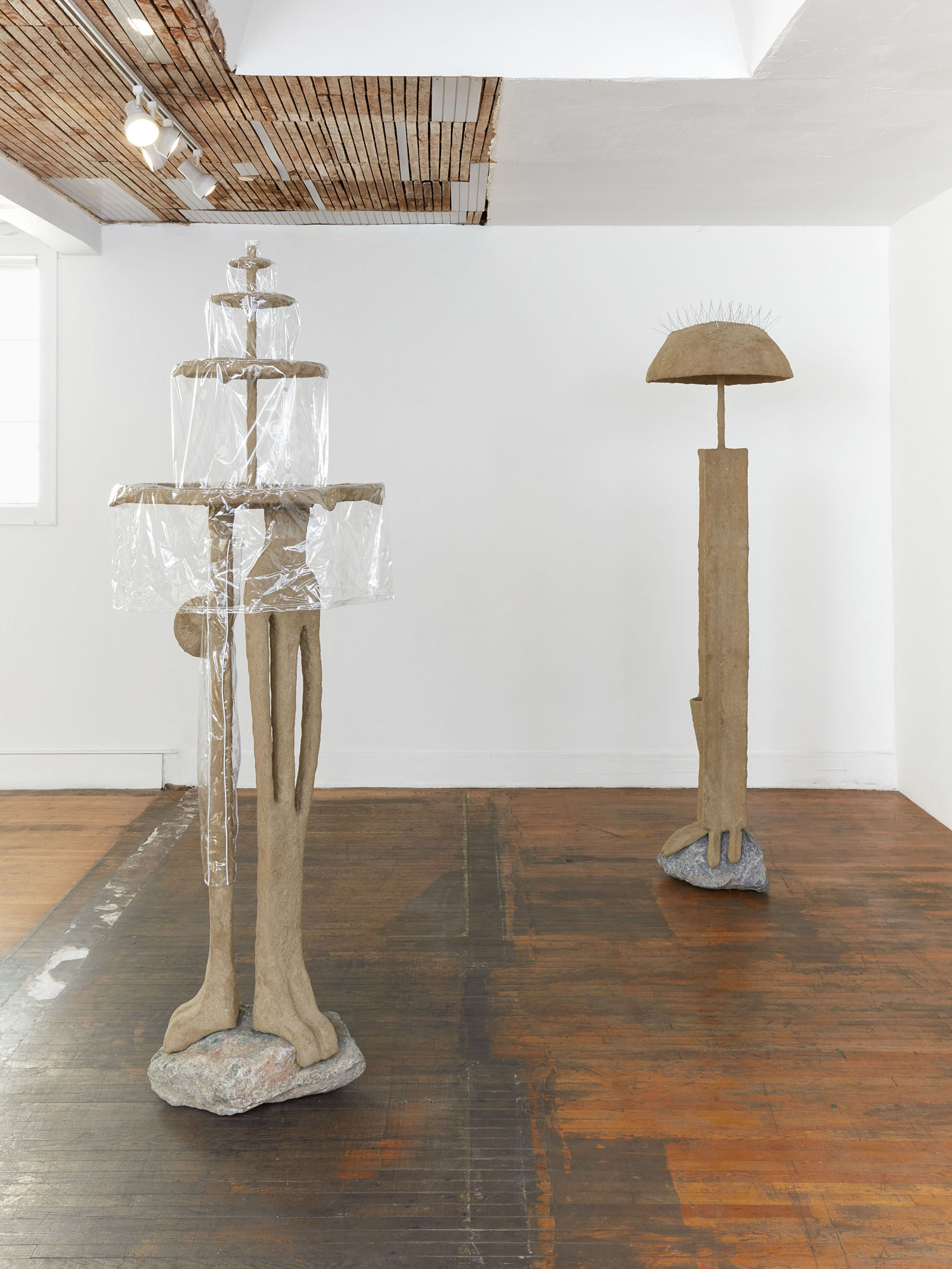 Thirst Trap (installation view), 2021, steel, sand, polymer, burlap, rock, vinyl, shower curtain hooks, toothbrushes