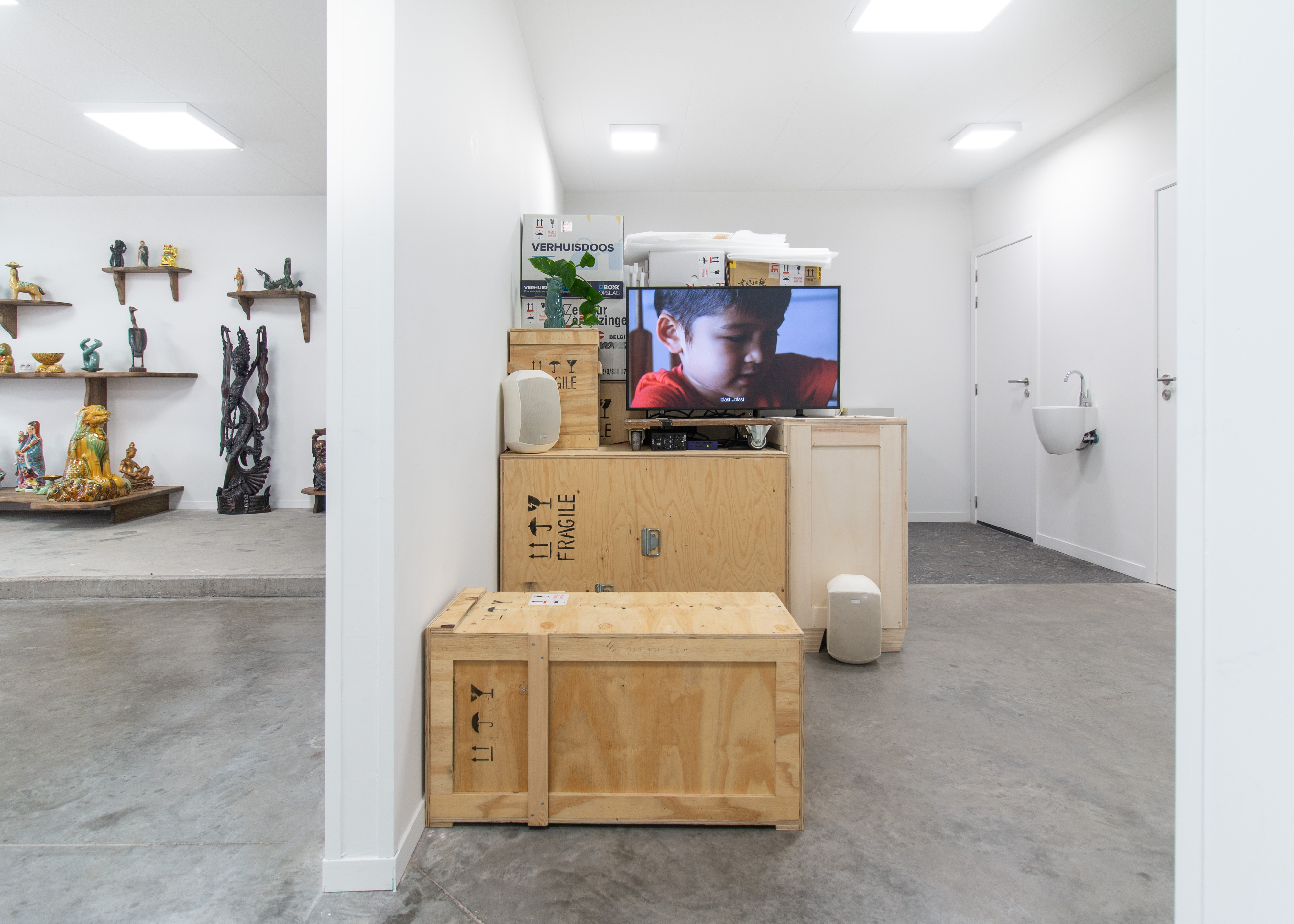 Unstoppable (Levi at table) (video installation, Every Love Story Is a Ghost Story)Single channel video, 3:41Wooden crates, cardboard boxes and packaging materials; porcelain vase and house plant