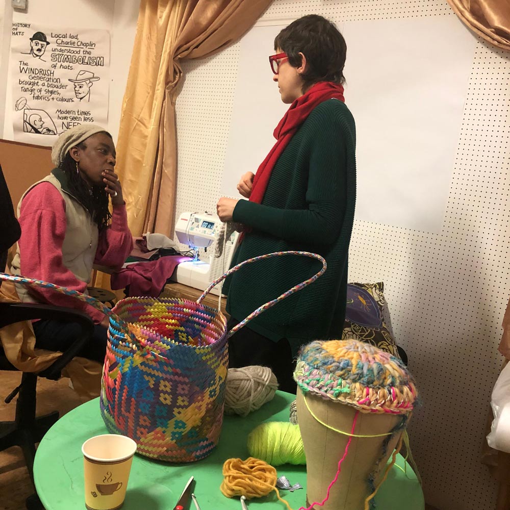Hat makers sharing skills.