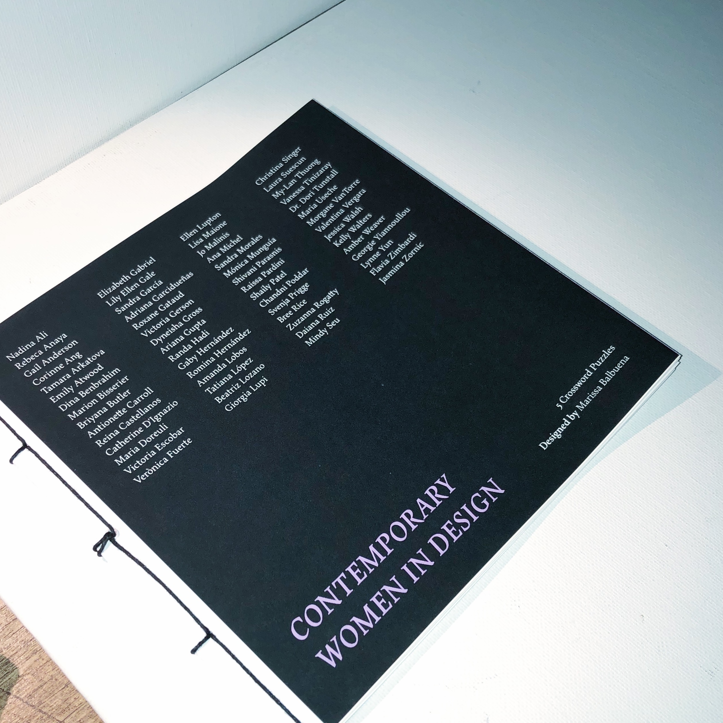 Front cover of crossword puzzle book. Includes names of all 60 women designers.