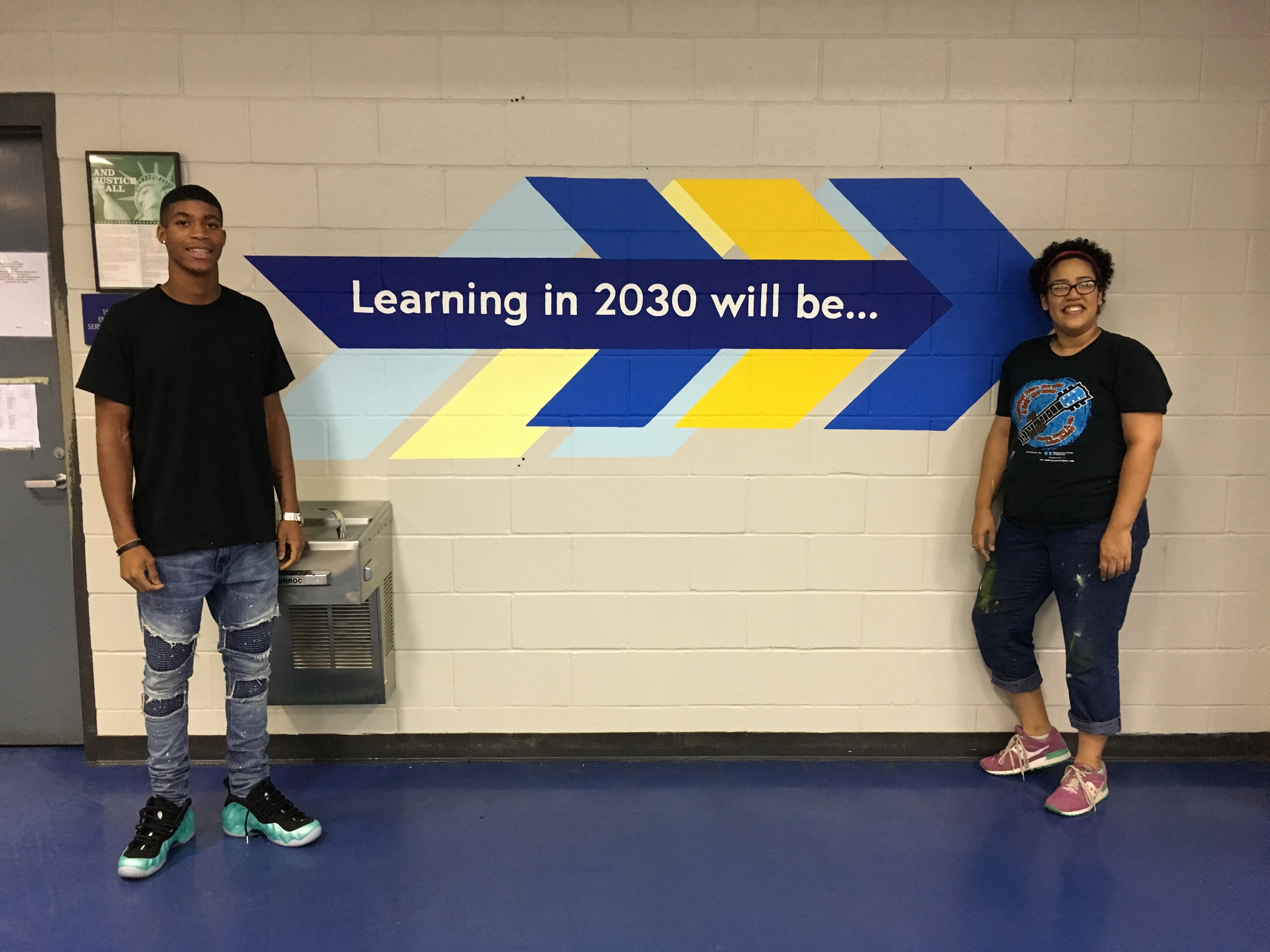 Terry High School student AJ Hill and artist Lesley Collins at Raymond High School